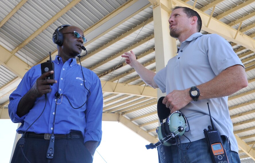 Garfield Gray, left, wireless system representative, and Master Sgt. Justin Johnston, 442nd Fighter Wing ground safety manager, demonstrate an Air Force-approved wireless system at Whiteman Air Force Base, Mo., June 26, 2013.This system allows maintenance workers to communicate in excessively noisy situations while preserving the hearing of the worker through noise-reducing technologies. One of the 442nd Fighter Wing safety office’s ongoing missions is to stay on the forefront of technological advances in advancing workplace safety. (U.S. Air Force photo by Airman 1st Class Keenan Berry/Released)