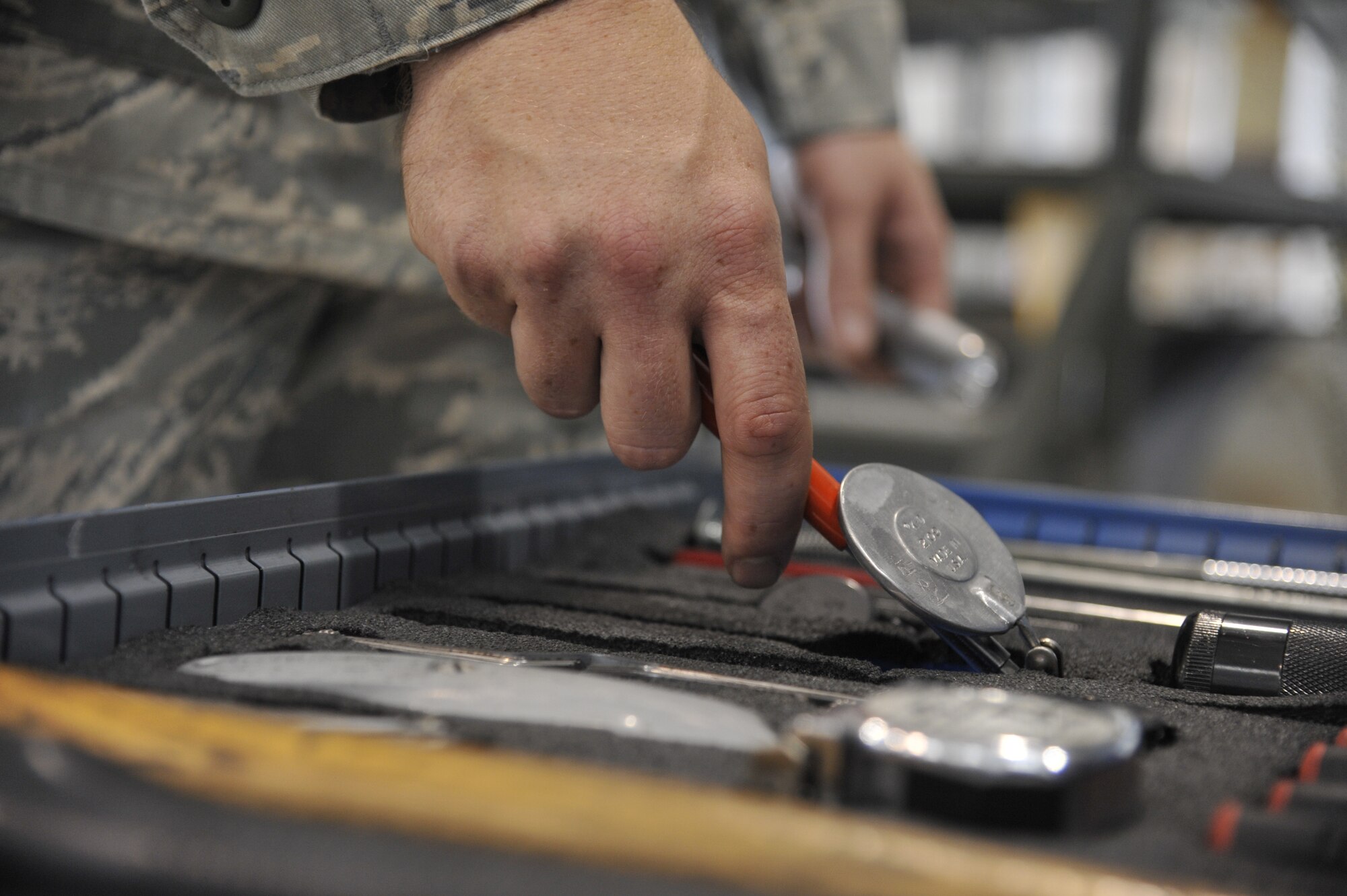 Tech. Sgt. Michael Schuler, 442nd Maintenance Squadron phase dock technician, grabs a round mirror and flashlight for an A-10 Thunderbolt II engine inspection at Whiteman Air Force Base, Mo., June 11, 2013.  The mirror helps technicians see into spaces of the jet too tight to look into directly and the flashlight is used to illuminate areas within engines, panels and wheel wells. (U.S. Air Force photo by Airman 1st Class Keenan Berry/Released)	