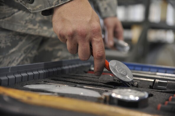 Tech. Sgt. Michael Schuler grabs a round mirror and flashlight for an A-10 Thunderbolt II engine inspection June 11, 2013, at Whiteman Air Force Base, Mo. The mirror helps technicians see into spaces of the jet too tight to look into directly and the flashlight is used to illuminate areas within engines, panels and wheel wells. Schuler is a 442nd Maintenance Squadron phase dock technician. (U.S. Air Force photo/Airman 1st Class Keenan Berry)