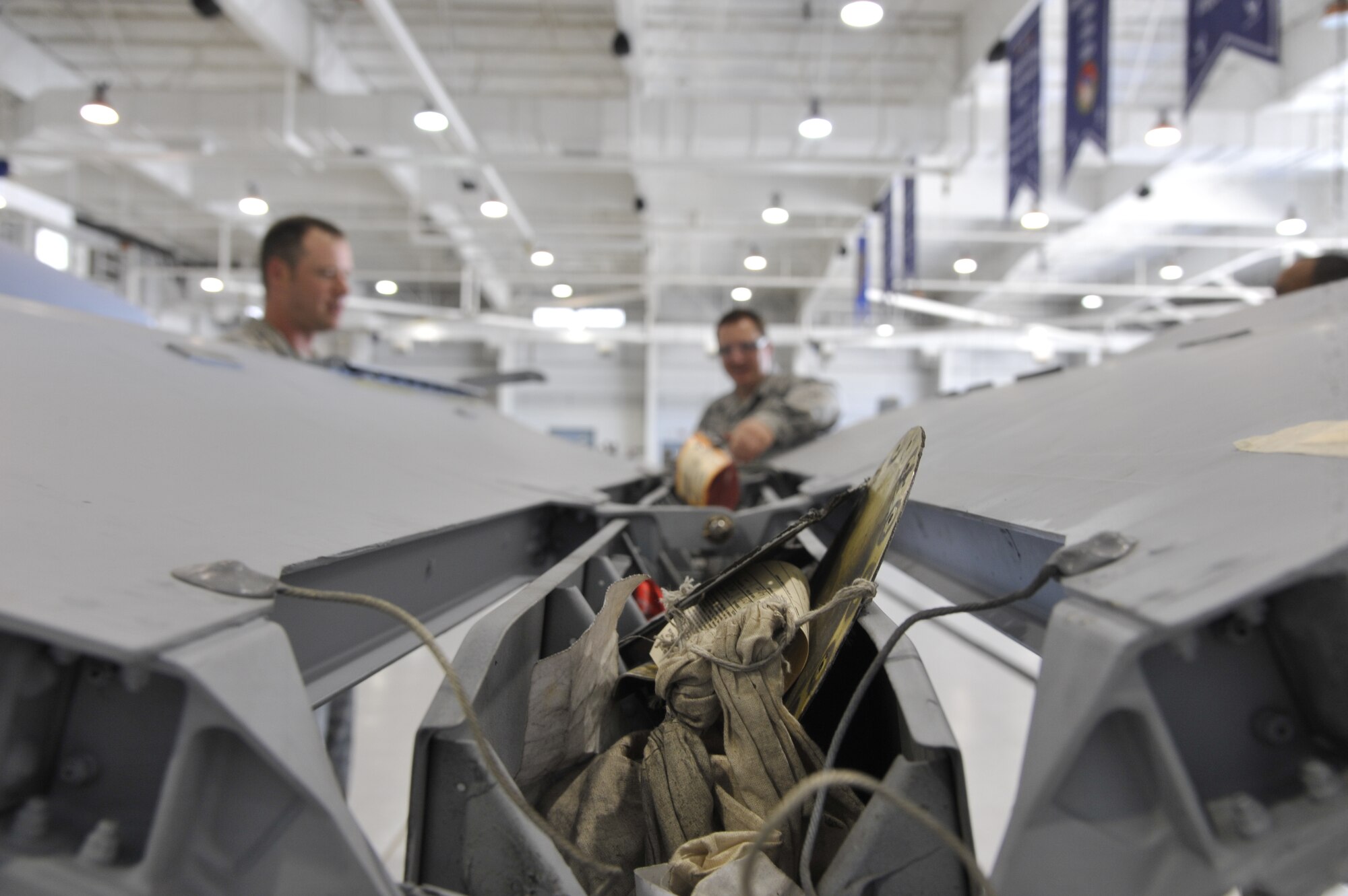 Tech. Sgt. Michael Schuler, 442nd Maintenance Squadron phase dock technician, and Tech. Sgt. Brandon Thompson, 442nd MXS phase dock coordinator, route the hydraulic lines of a speed brake actuator on an A-10 Thunderbolt II at Whiteman Air Force Base, Mo., June 11, 2013. Thompson is performing a clearance check, ensuring the lines are not rubbing against each other or air frame components, which could cause short-circuiting.  (U.S. Air Force photo by Airman 1st Class Keenan Berry/Released)