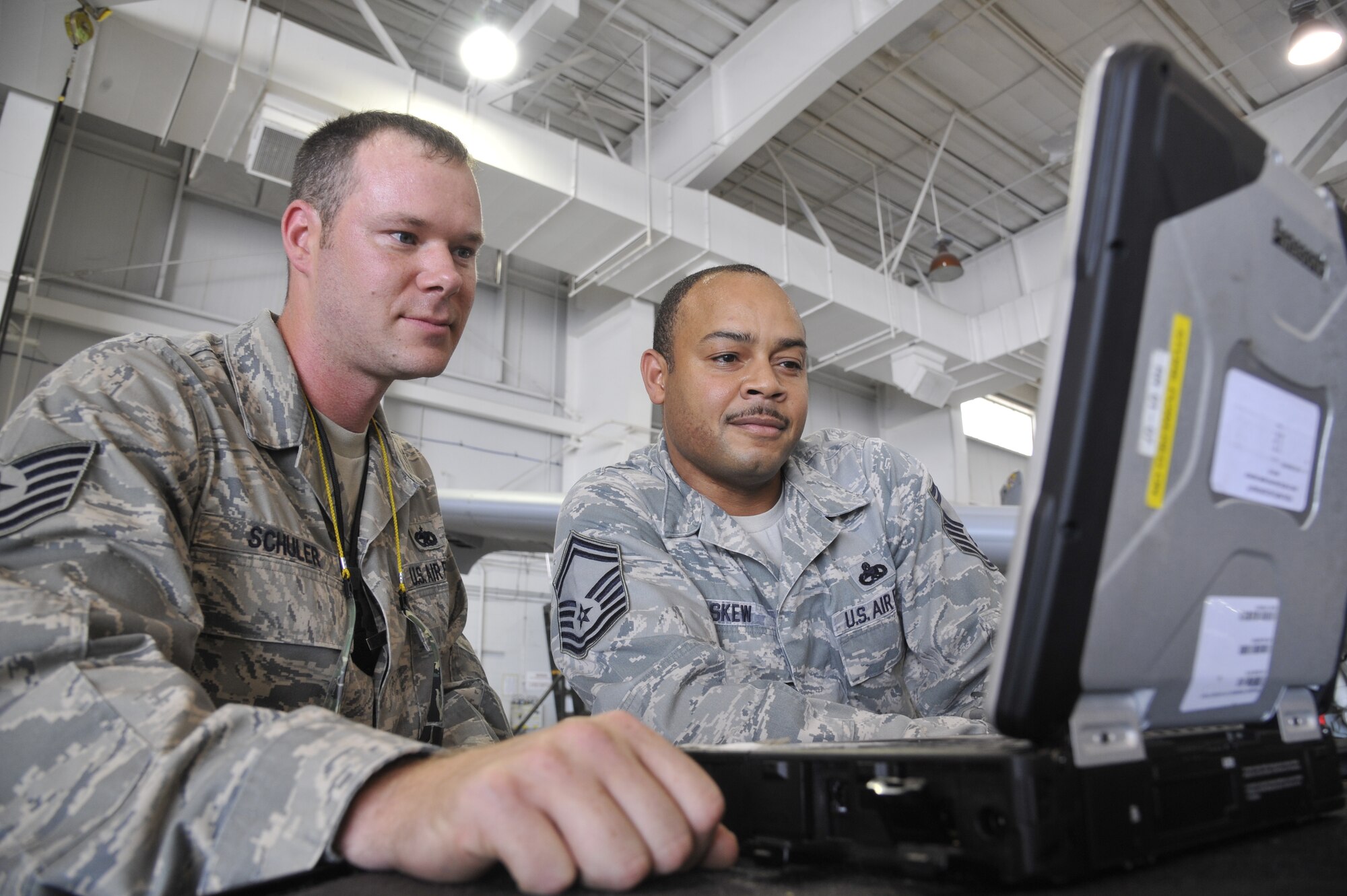 Tech. Sgt. Michael Schuler, 442nd Maintenance Squadron phase dock technician, and Senior Master Sgt. Kellie Askew, 442nd MXS phase dock flight chief, review technical data on the canopy of an A-10 Thunderbolt II at Whiteman Air Force Base, Mo.,  June 11, 2013. They are searching for any faults within the A-10’s canopy-closing mechanisms. (U.S. Air Force photo by Airman 1st Class Keenan Berry/Released)