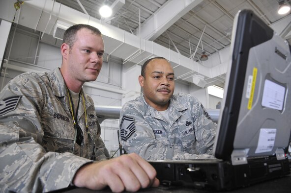 Tech. Sgt. Michael Schuler and Senior Master Sgt. Kellie Askew review technical data on the canopy of an A-10 Thunderbolt II June 11, 2013, at Whiteman Air Force Base, Mo. They are searching for any faults within the A-10’s canopy-closing mechanisms. Schuler is a 442nd Maintenance Squadron phase dock technician and Askew is the 442nd MXS phase dock flight chief. (U.S. Air Force photo/Airman 1st Class Keenan Berry)