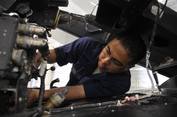 Tech. Sgt. Rodney Transfiguracion repairs canopy closing mechanisms on an A-10 Thunderbolt II June 11, 2013, at Whiteman Air Force Base, Mo. Transfiguracion is working to determine why this particular canopy is not locking; the canopy must lock to ensure the pilot is safe and secure in the cockpit. Transfiguracion is a 442nd Maintenance Squadron repair and reclamation technician. (U.S. Air Force photo/Airman 1st Class Keenan Berry)