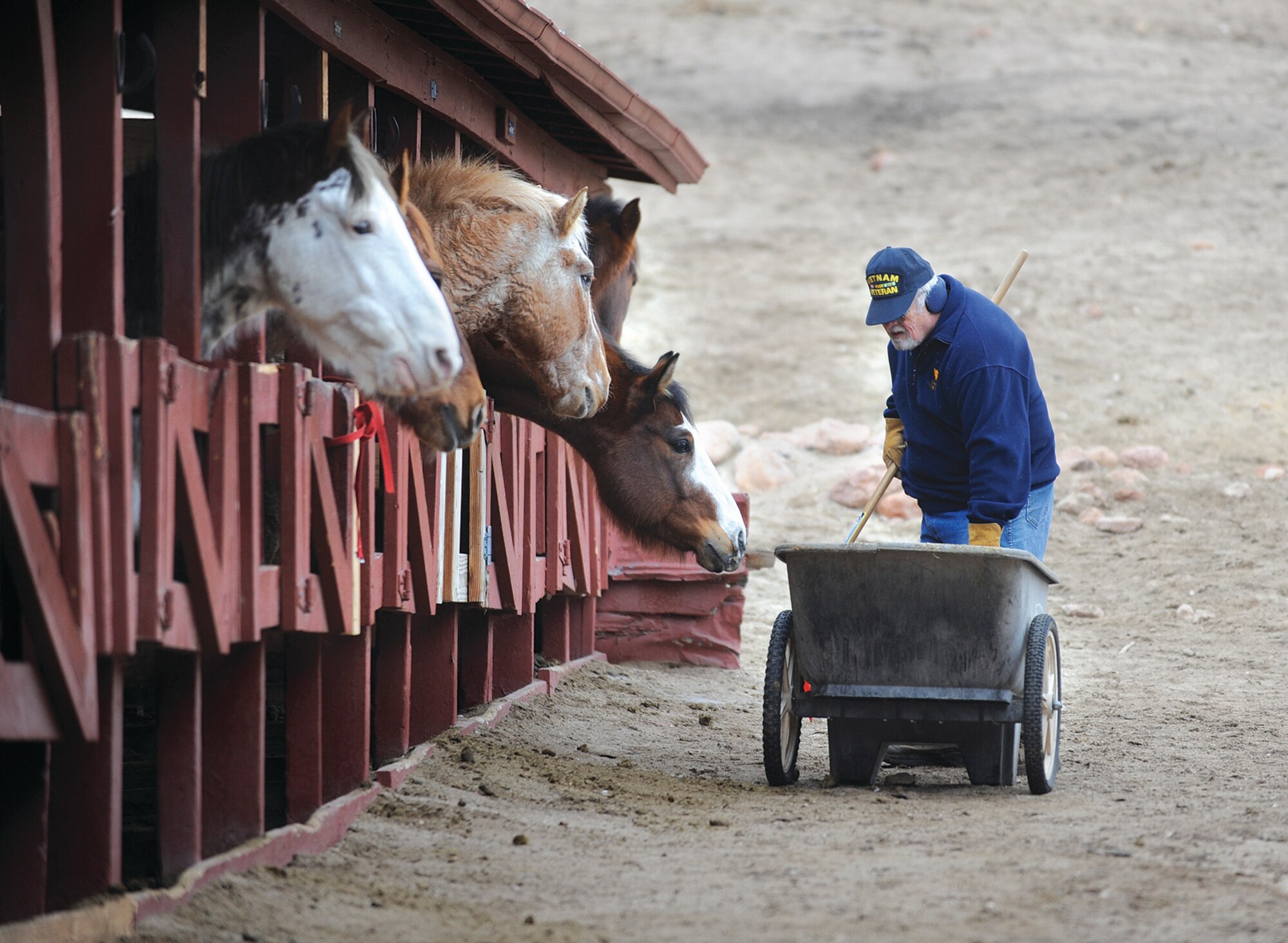 Charlie Dye cleans the exterior of a row of stables at the Equestrian Center in March. The Academy stabled about 27 horses evacuated from the Black Forest Fire June 11-15. (U.S. Air Force Photo/Carol Lawrence)