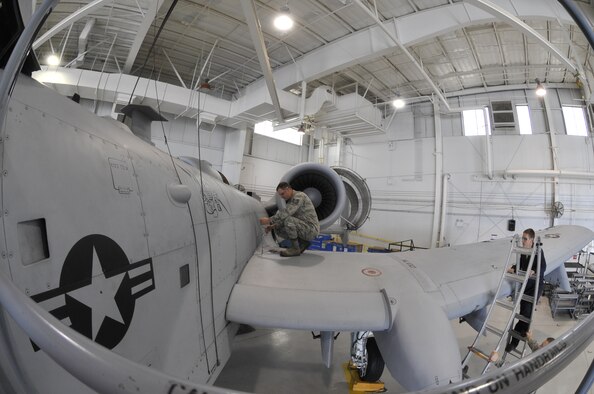 Tech. Sgt. Michael Schuler removes panel F-83 off an A-10 Thunderbolt II June 11, 2013, at Whiteman Air Force Base, Mo. Removing this panel enables maintenance techs to inspect the A-10 and locate any internal discrepancies. Schuler is a 442nd Maintenance Squadron phase dock technician. (U.S. Air Force photo/Airman 1st Class Keenan Berry)