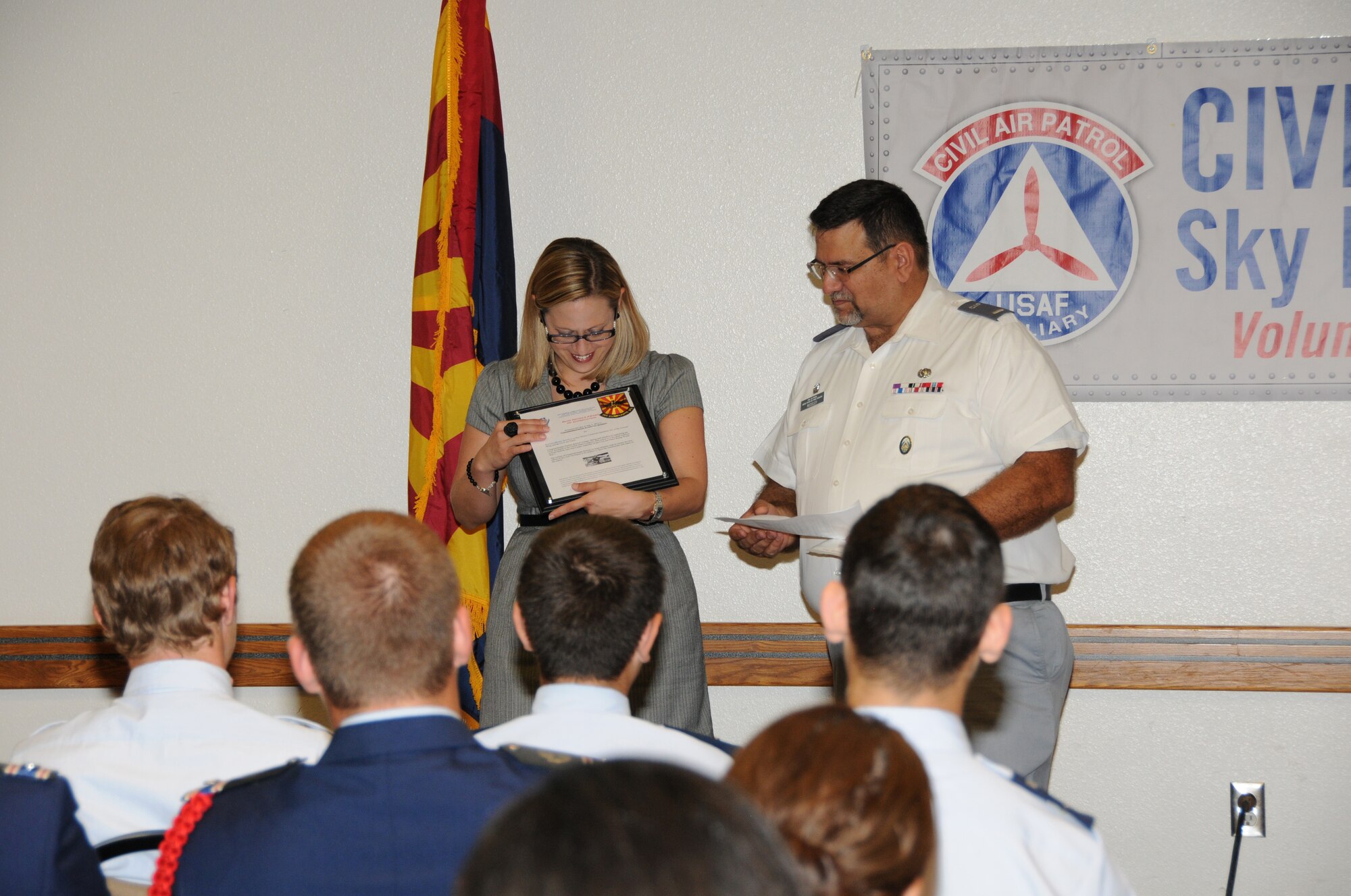 Civil Air Patrol 2LT Moseley presents Congresswoman Kyrsten Sinema with the Ruth Nichols Award of Appreciation at the 161st Air Refueling Wing July 1, 2013.  They award was presented to the Congresswoman for her support of the Sky Harbor Squadron 301, Arizona Wing Civil Air Patrol unit. (U.S. Air National Guard photo by Master Sgt. Kelly M. Deitloff/Released)