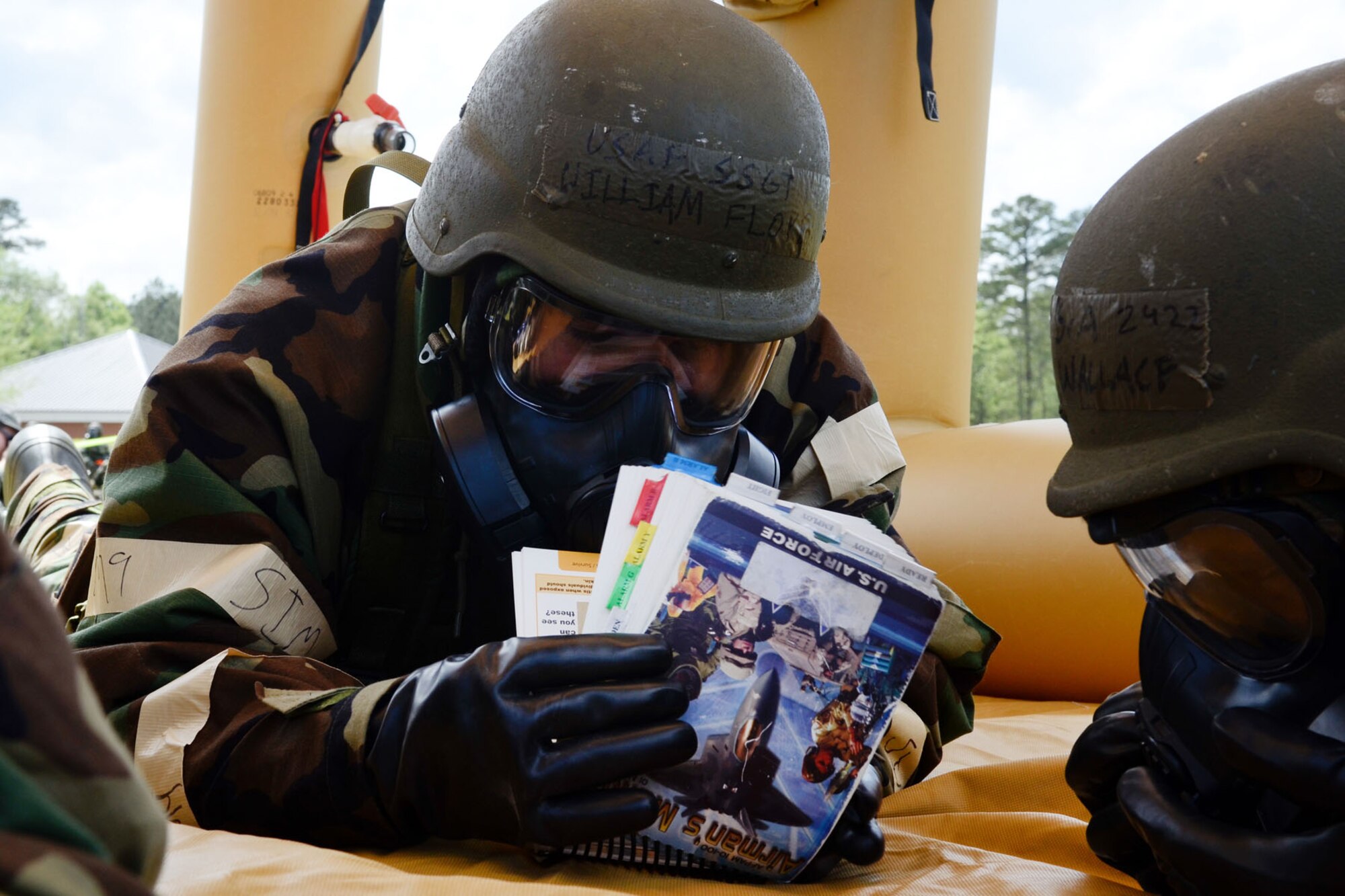 U.S. Air Force Staff Sgt. William Floyd, assigned to the 169th Fighter Wing of the South Carolina Air National Guard, reads his Airman's Manual during a simulated chemical attack during the 169th Fighter Wing Readiness Exercise, McEntire Joint National Guard Base, S.C., April 12, 2013. Members of the 169th Fighter Wing are preparing for a Phase I and II Readiness Inspection, which evaluates a unit's ability to deploy, then operate and launch missions in a chemical combat environment.  (U.S. Air National Guard photo by Staff Sgt. Jorge Intriago/Released)