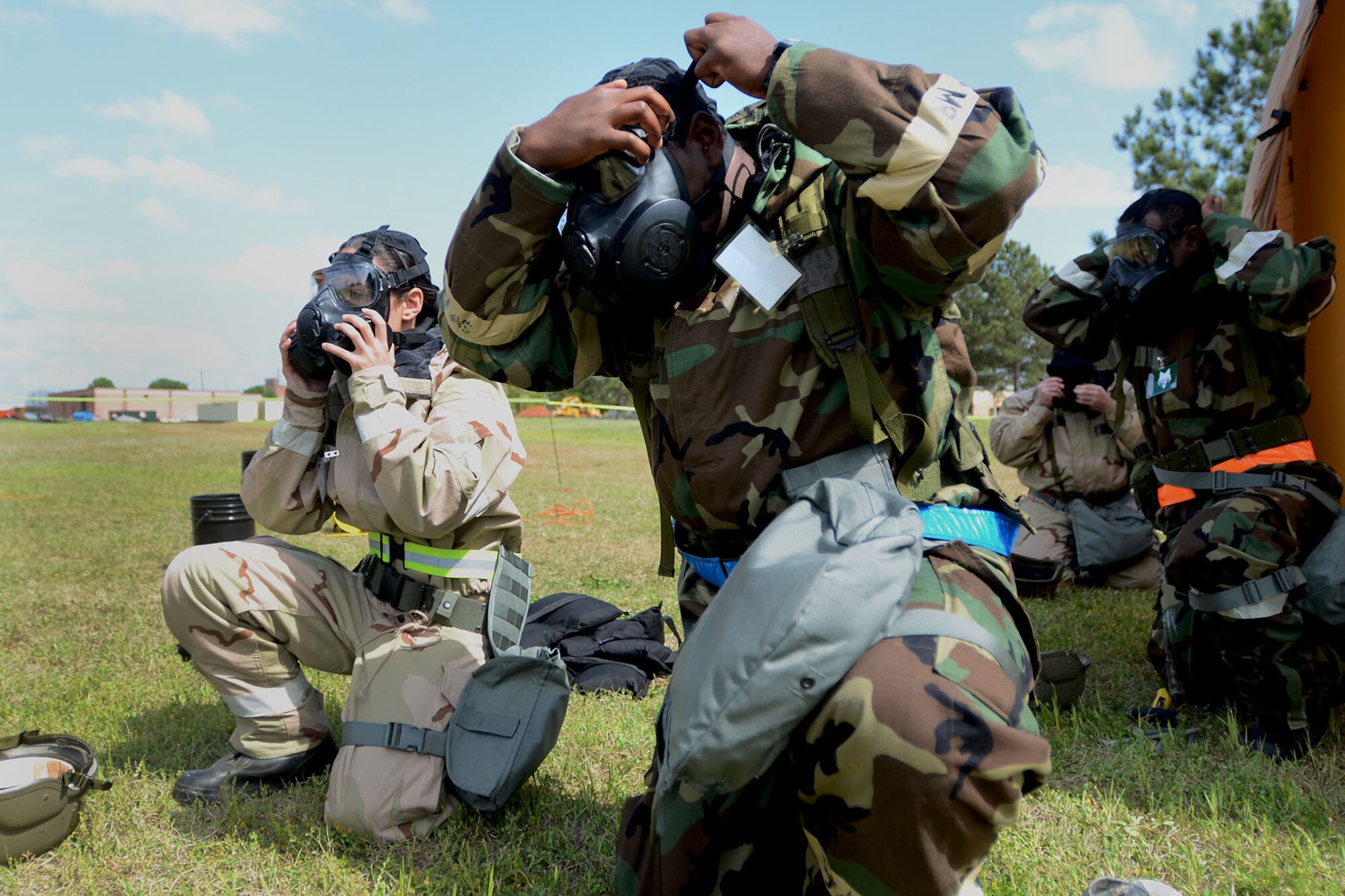 U.S. Air Force Airmen with the 169th Fighter Wing at McEntire Joint National Guard Base, S.C., don their gas masks in response to a simulated chemical attack during a Readiness Exercise, April 12, 2013. Members of the 169th Fighter Wing are preparing for a Phase I and II Readiness Inspection, which evaluates a unit's ability to deploy, then operate and launch missions in a chemical combat environment.  (U.S. Air National Guard photo by Tech. Sgt. Caycee Watson/Released)
