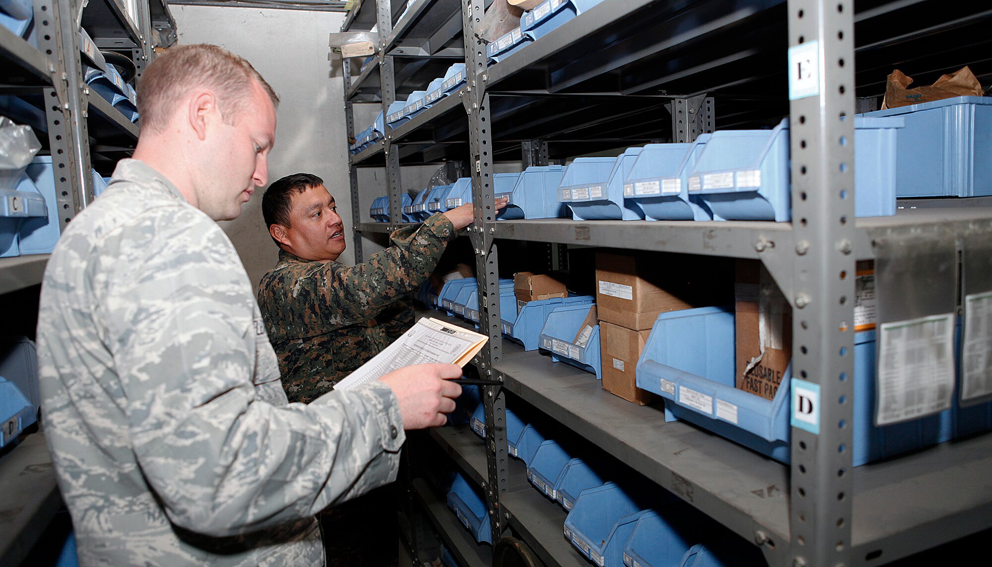 Captain Jarret Flexman, 571st Mobility Support Advisory Squadron logistics air advisor, discusses how to conduct an inventory for the Guatemalan supply warehouses, with members of the Guatemalan air force during the MSAS Building Partnership Capacity mission May 5?June 14, at La Aurora Air Base, Guatemala.  (U.S. Air Force photo by Tech. Sgt. Javier Borges)