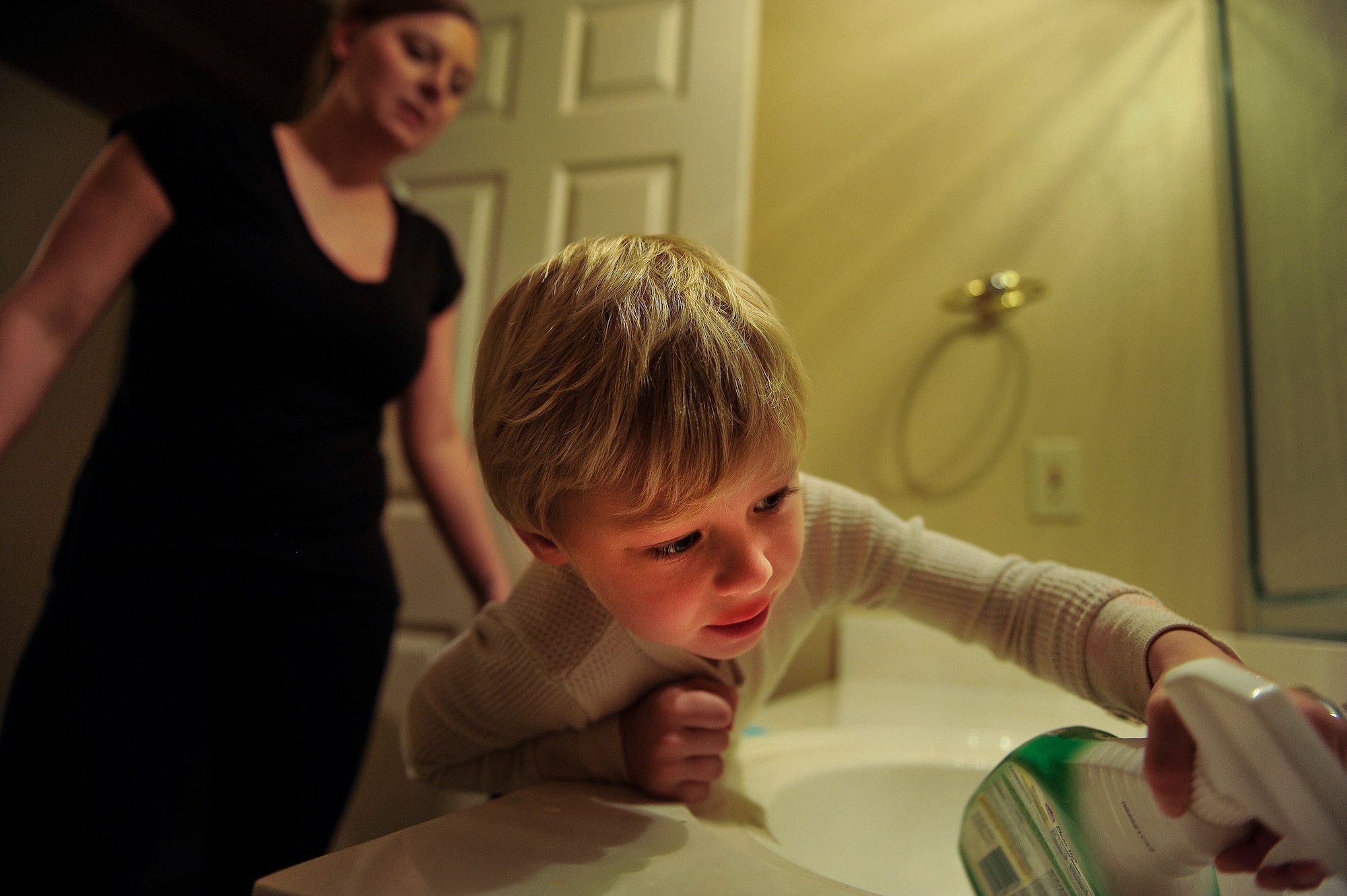 Ayden Drain cleans the sink, after smearing toothpaste in the bathroom of the family’s home Jan. 17, 2013, in Cabot, Ark. His mother, Heather Drain, had limited help and spent most of her days picking up after her young boys.  (U.S. Air Force photo by Staff Sgt. Russ Scalf)