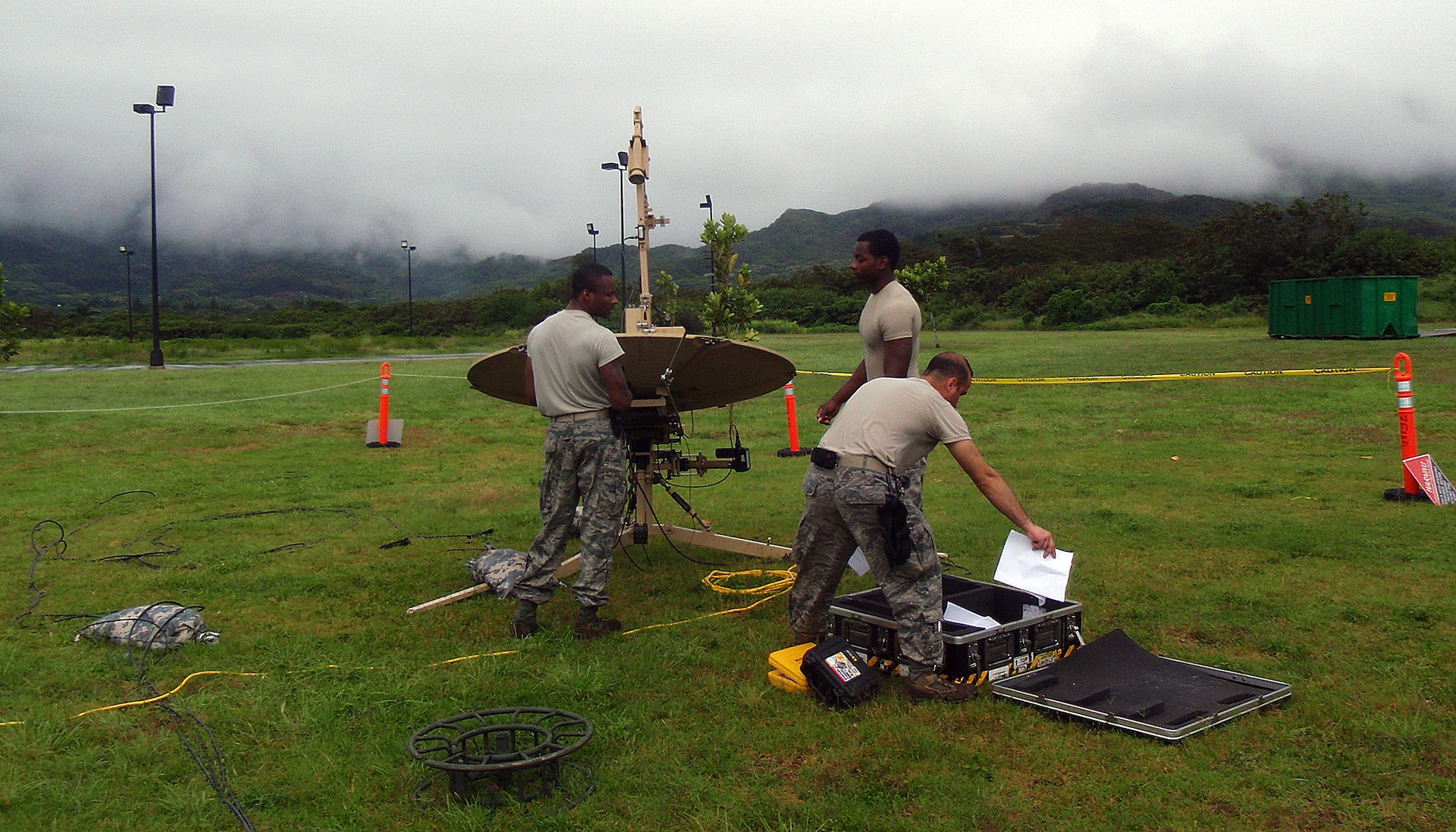 Staff Sgt. Mark Harrison (left), 573rd Global Support Squadron Small Package Initial Communications Element assistant NCOIC, instructs Airman 1st Class Demetri Hoskins, 573rd GSS SPICE systems technician, on steps to manually acquire the satellite in order to receive internet services during a recent Makani Pahili Hurricane Exercise, in Waimanalo, HI.  Staff Sgt. George Kreopolidis (right), 573rd GSS cyber transport systems supervisor, secures the satellite coordinates from the case.  SPICE delivers regular and secure electronic mail and secure/non-secure voice communications to bare-base deployed locations. (U.S. Air Force photo by Tech. Sgt. Daniel Lane)
