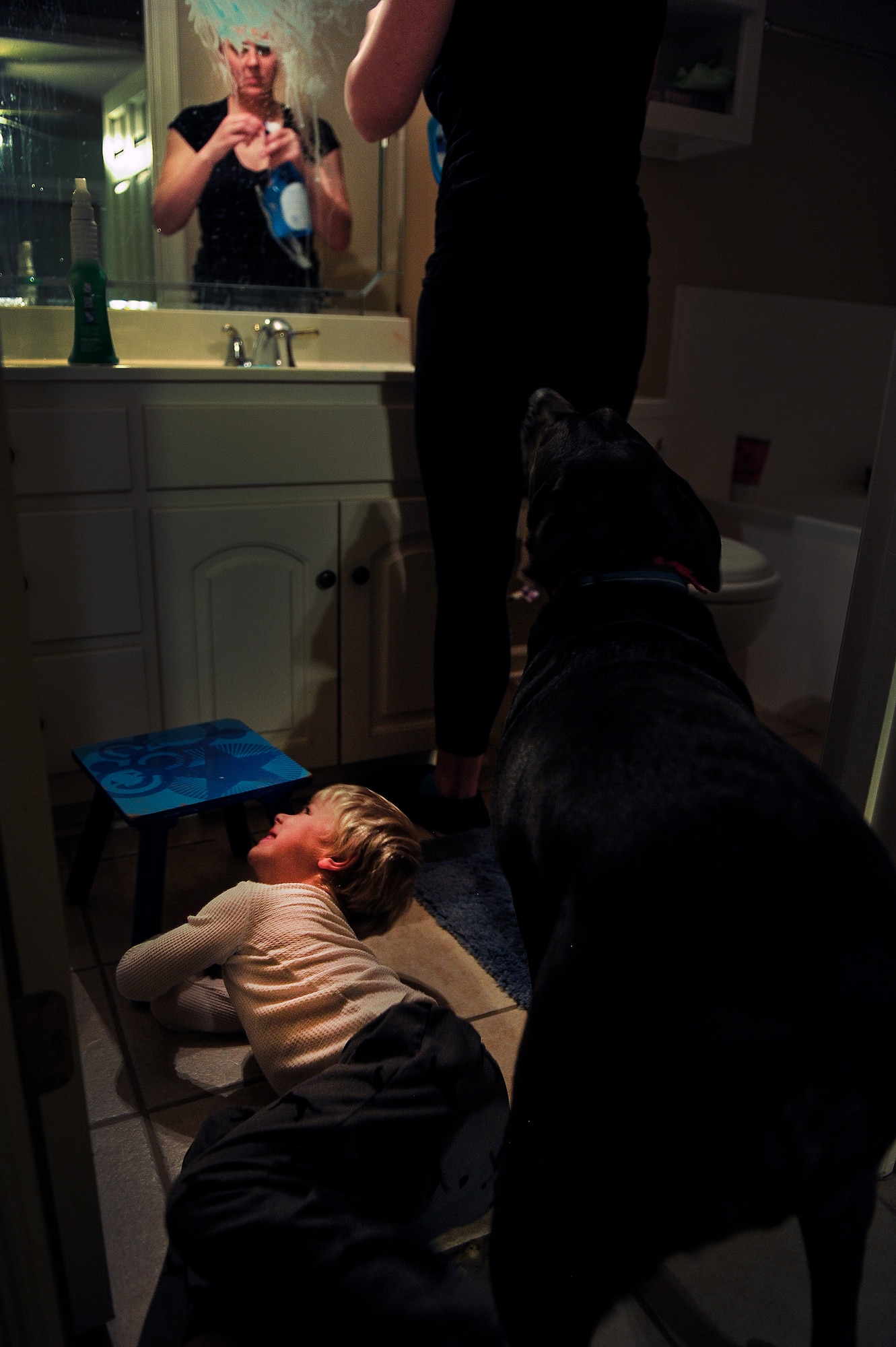 Heather Drain cleans toothpaste from a mirror at her home Jan. 17, 2013, in Cabot, Ark. Her oldest son, Ayden, smeared the toothpaste on the mirror earlier in the day. Many of Drain’s days were spent cleaning messes created by her young children.  (U.S. Air Force photo by Staff Sgt. Russ Scalf)