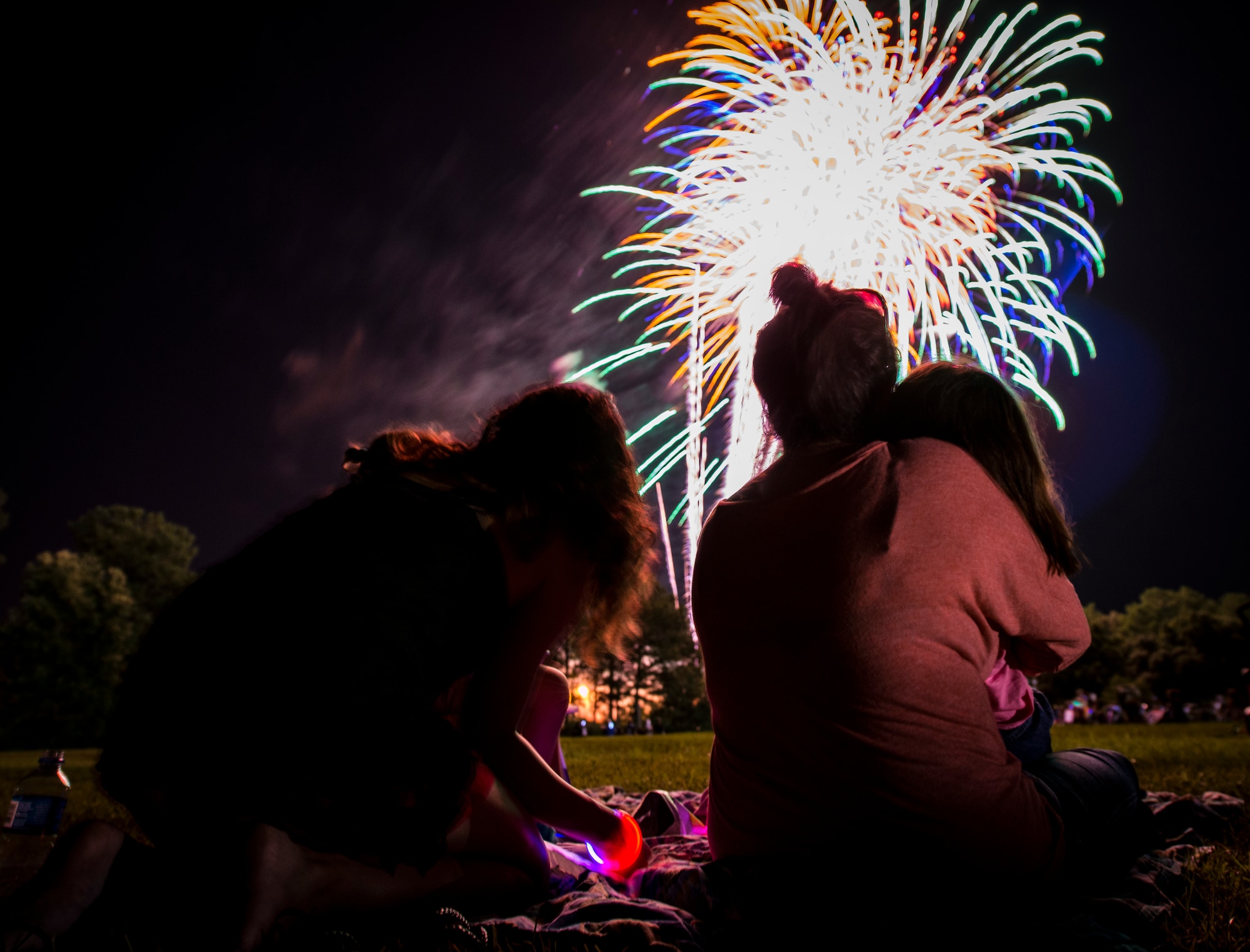 Military dependents enjoy a fireworks show June 28, during the 2013 Freedom Fest at Marrington Plantation at Joint Base Charleston – Weapons Station, S.C. Nearly 1,500 Airmen, Sailors, civilians and their families attended the celebration which included food, drinks, festival rides, music and fireworks. (U.S. Air Force photo/ Senior Airman Dennis Sloan)