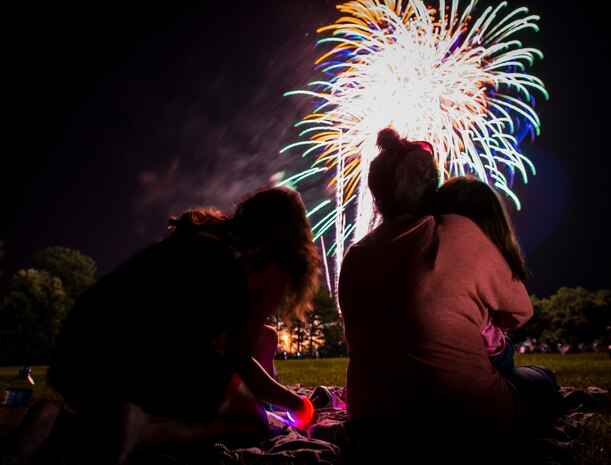Military dependents enjoy a fireworks show June 28, during the 2013 Freedom Fest at Marrington Plantation at Joint Base Charleston – Weapons Station, S.C. Nearly 1,500 Airmen, Sailors, civilians and their families attended the celebration which included food, drinks, festival rides, music and fireworks. (U.S. Air Force photo/ Senior Airman Dennis Sloan)