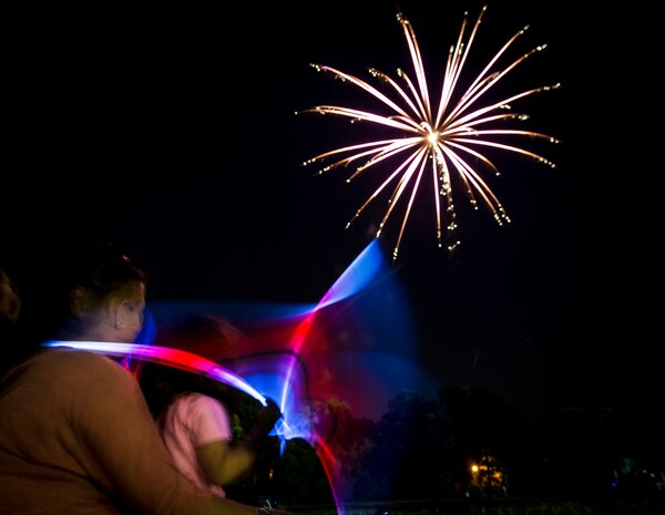 Military dependents enjoy a fireworks show June 28, during the 2013 Freedom Fest at Marrington Plantation at Joint Base Charleston – Weapons Station, S.C. Nearly 1,500 Airmen, Sailors, civilians and their families attended the celebration which included food, drinks, festival rides, music and fireworks. (U.S. Air Force photo/ Senior Airman Dennis Sloan)