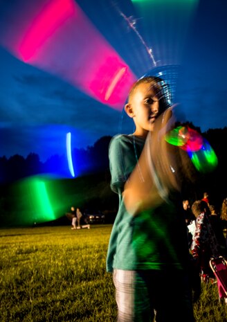 A military dependent twirls a light stick June 28, during the 2013 Freedom Fest at Marrington Plantation at Joint Base Charleston – Weapons Station, S.C. Nearly 1,500 Airmen, Sailors, civilians and their families attended the celebration which included food, drinks, festival rides, music and fireworks. (U.S. Air Force photo/ Senior Airman Dennis Sloan)