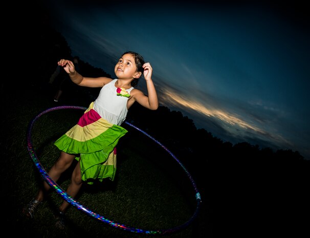 A military dependent hula hoops June 28, during the 2013 Freedom Fest at Marrington Plantation at Joint Base Charleston – Weapons Station, S.C. Nearly 1,500 Airmen, Sailors, civilians and their families attended the celebration which included food, drinks, festival rides, music and fireworks. (U.S. Air Force photo/ Senior Airman Dennis Sloan)