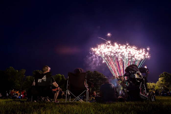 Military members and their families watch the fireworks in the sky, June 28, during the 2013 Freedom Fest at Marrington Plantation at Joint Base Charleston – Weapons Station, S.C. Nearly 1,500 Airmen, Sailors, civilians and their families attended the celebration which included food, drinks, festival rides, music and fireworks. (U.S. Air Force photo/ Senior Airman George Goslin)