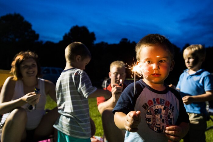 Ryan Pefley, son of Chief Petty Officer David Pefley, a machinist’s mate at the Naval Nuclear Power Training Command, shows off his sparkler June 28, during the 2013 Freedom Fest at Marrington Plantation at Joint Base Charleston – Weapons Station, S.C. Nearly 1,500 Airmen, Sailors, civilians and their families attended the celebration which included food, drinks, festival rides, music and fireworks. (U.S. Air Force photo/ Senior Airman George Goslin)