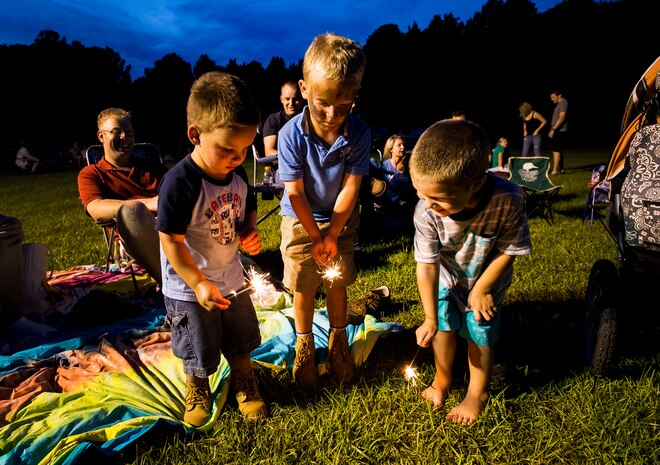 (Left) Caleb and (middle) Ryan Pefley, sons of Chief Petty Officer David Pefley, a machinist’s mate at the Naval Nuclear Power Training Command, and Waylon Fullmer, son of Chief Petty Officer Bruce Fullmer , a machinist’s mate at the Naval Nuclear Power Training Command, play with sparklers June 28, during the 2013 Freedom Fest at Marrington Plantation at Joint Base Charleston – Weapons Station, S.C. Nearly 1,500 Airmen, Sailors, civilians and their families attended the celebration which included food, drinks, festival rides, music and fireworks. (U.S. Air Force photo/ Senior Airman George Goslin)