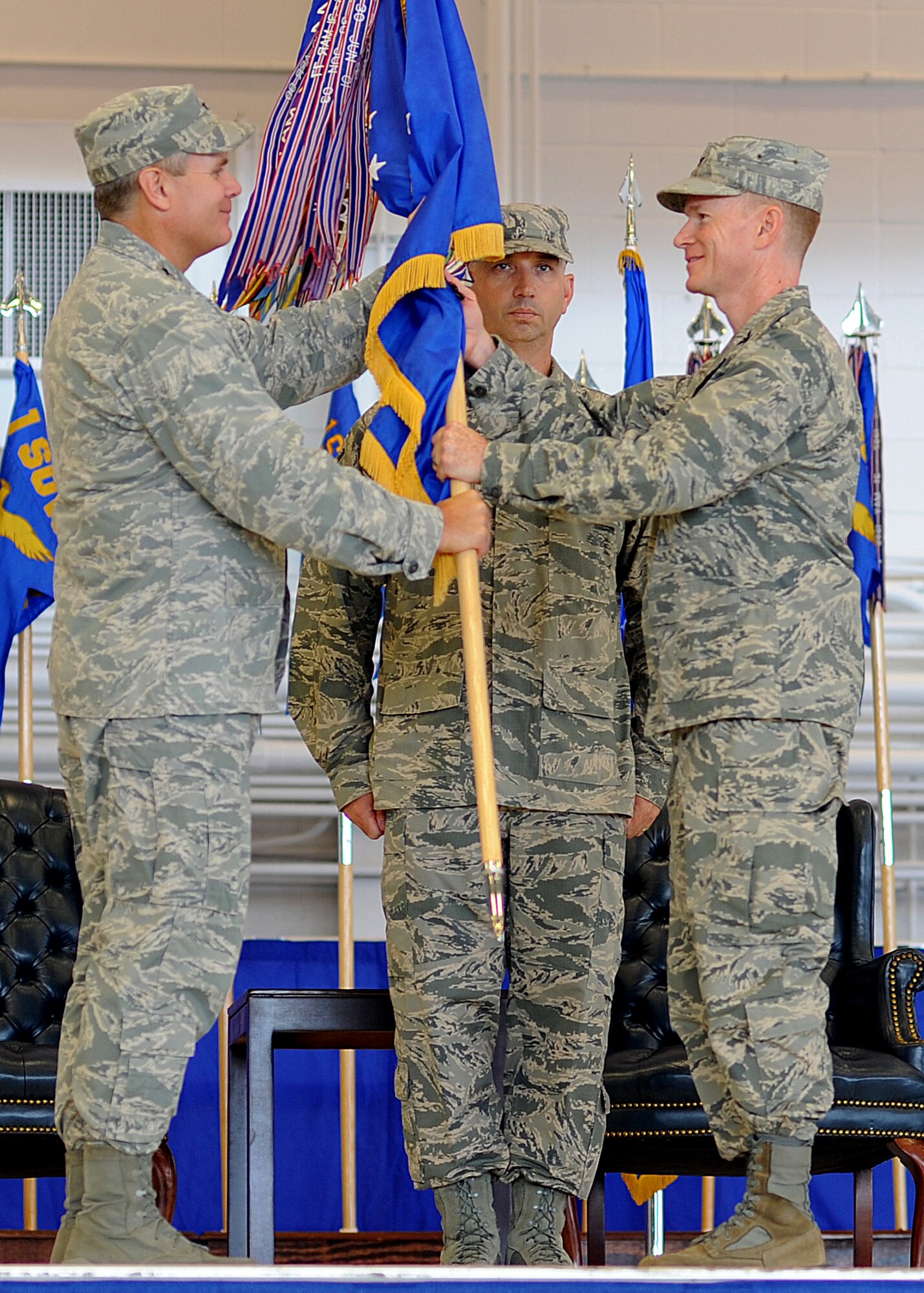 Col. William West, right, commander of the 1st Special Operations Wing, takes the 1st SOW guideon from Lt. Gen. Eric Fiel, commander of Air Force Special Operations Command, left, during the wing’s change of command ceremony at the Freedom Hangar on Hurlburt Field, Fla., July 3, 2013. Col. Jim Slife relinquished command of 1st SOW to West, former 27th Special Operations Group commander at Cannon Air Force Base, N.M. (U.S. Air Force photo/Senior Airman Kentavist Brackin) 
