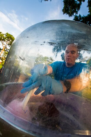 Staff Sgt. Jeremy Micka, 628th Civil Engineer Squadron water and fuels systems craftsman, stirs cotton candy June 28, during the 2013 Freedom Fest at Marrington Plantation at Joint Base Charleston – Weapons Station, S.C. Nearly 1,500 Airmen, Sailors, civilians and their families attended the celebration which included food, drinks, festival rides, music and fireworks. (U.S. Air Force photo/ Senior Airman George Goslin)