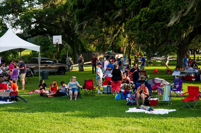 Military members and their families enjoy the festivities during the 2013 Freedom Fest June 28, at Marrington Plantation at Joint Base Charleston – Weapons Station, S.C. Nearly 1,500 Airmen, Sailors, civilians and their families attended the celebration which included food, drinks, festival rides, music and fireworks. (U.S. Air Force photo/ Senior Airman George Goslin)