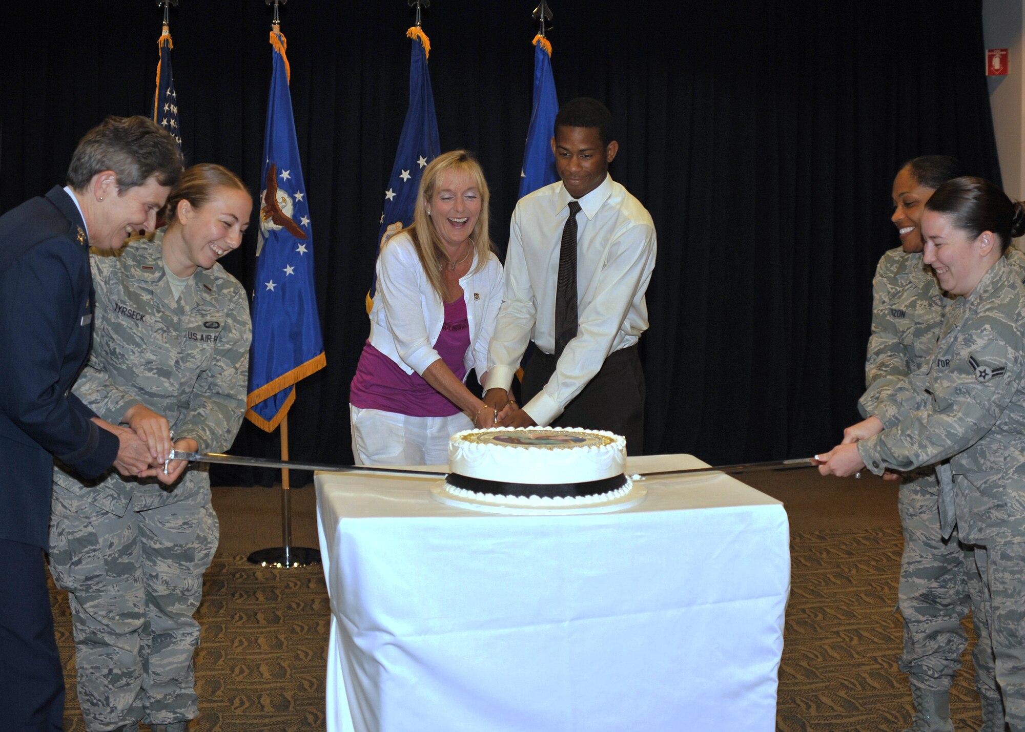 U.S. Air Force Lt. Gen. Ellen M. Pawlikowski (far left), commander of the Space and Missile Systems Center at Los Angeles Air Force Base in El Segundo, Calif., officiates the SMC Birthday and Monthly Recognition Ceremony.  which celebrates the 59-year-long history of SMC, recognizes recent award winners who are creating new history at SMC, and ceremonially cuts the SMC birthday cake with SMC leadership and most junior officer, enlisted, and civilian members on base. (U.S. Air Force photo by Sarah Corrice)