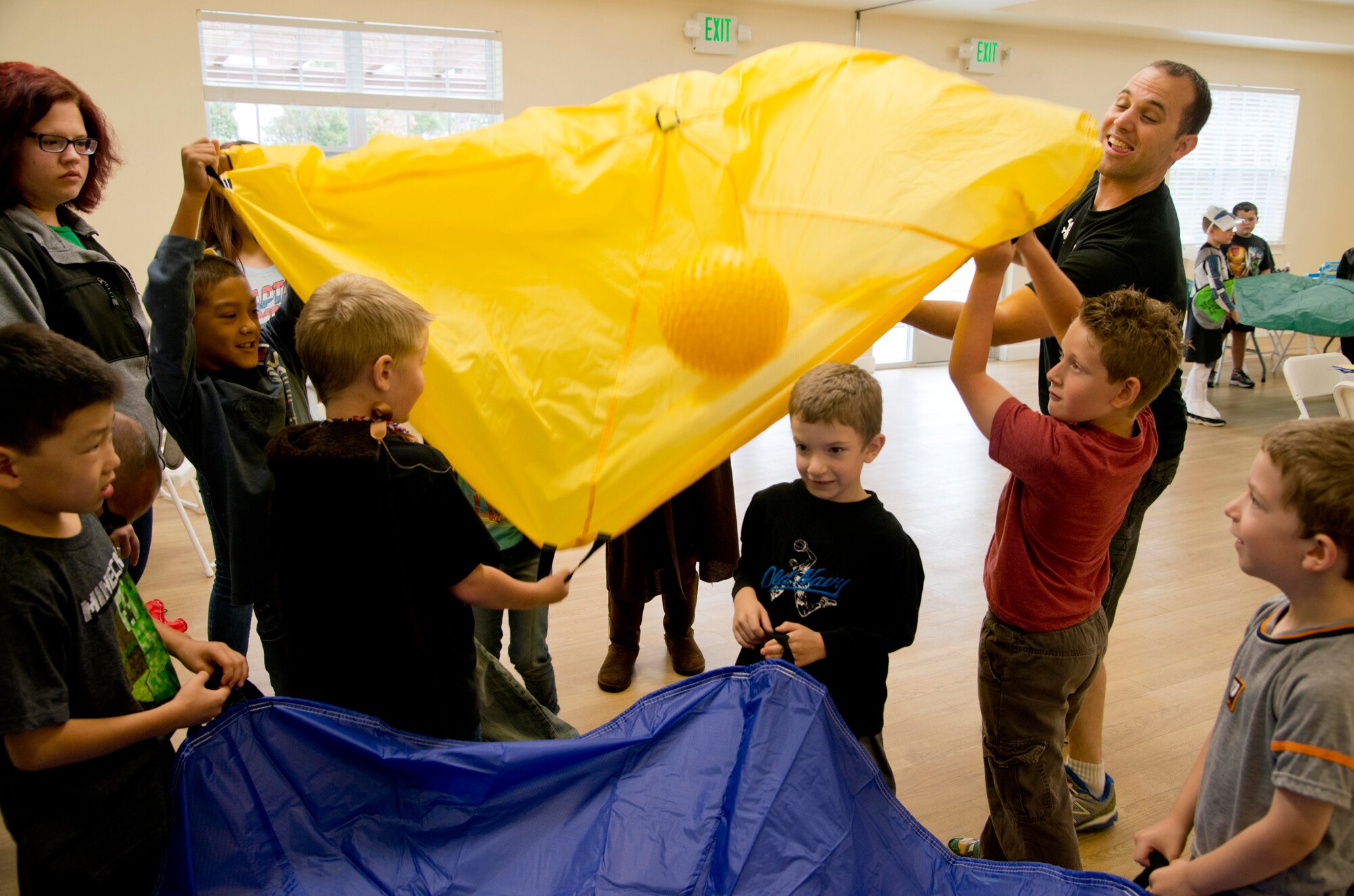 Tech. Sgt. Michael Offenbacker, 60th Maintenance Squadron metals technician, leads children in the EFMP Super Hero Camp in passing the "orb" and not letting it fall on the ground at the Balfour Beatty Community Center June 26, 2013 on base. Offenbacker teaches the children teamwork and patience. (U.S. Air Force
photo/Airman 1st Class Nicole Leidholm)
