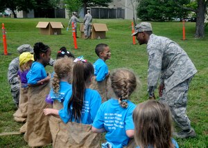Senior Airman James F. Davis Jr., 11th Logistics Readiness Squadron scheduled maintenance liaison, monitors the physical readiness station during the second annual Operation KID Mode, held June 28, 2013 at Joint Base Andrews, Md. Children at the staion learned about pre-deployment physical readiness through games like jumping jacks, tug-of-war and potato sack races. (U.S. Air Force photo/Senior Airman Lindsey A. Porter)