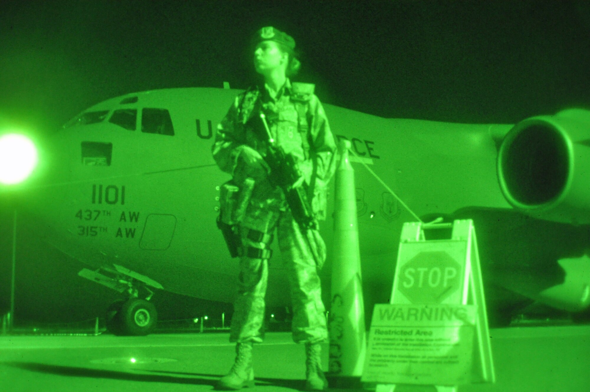 Senior Airman Danielle Reeves, 60th Security Forces Squadron member, guards an aircraft Sunday on the flightline on Travis. (U.S. Air Force photo/Staff Sgt. Patrick Harrower)