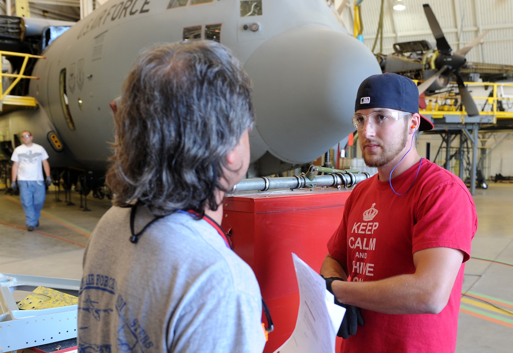 Christopher Staton (right) and NDI Specialist Mark Haase, both Robins sheet metal mechanics, take a moment to talk about an inboard engine truss mount that is about to be replaced on a C-130 at Hill AFB, Utah. (U.S, Air Force photo by Aley Lloyd/Released)
