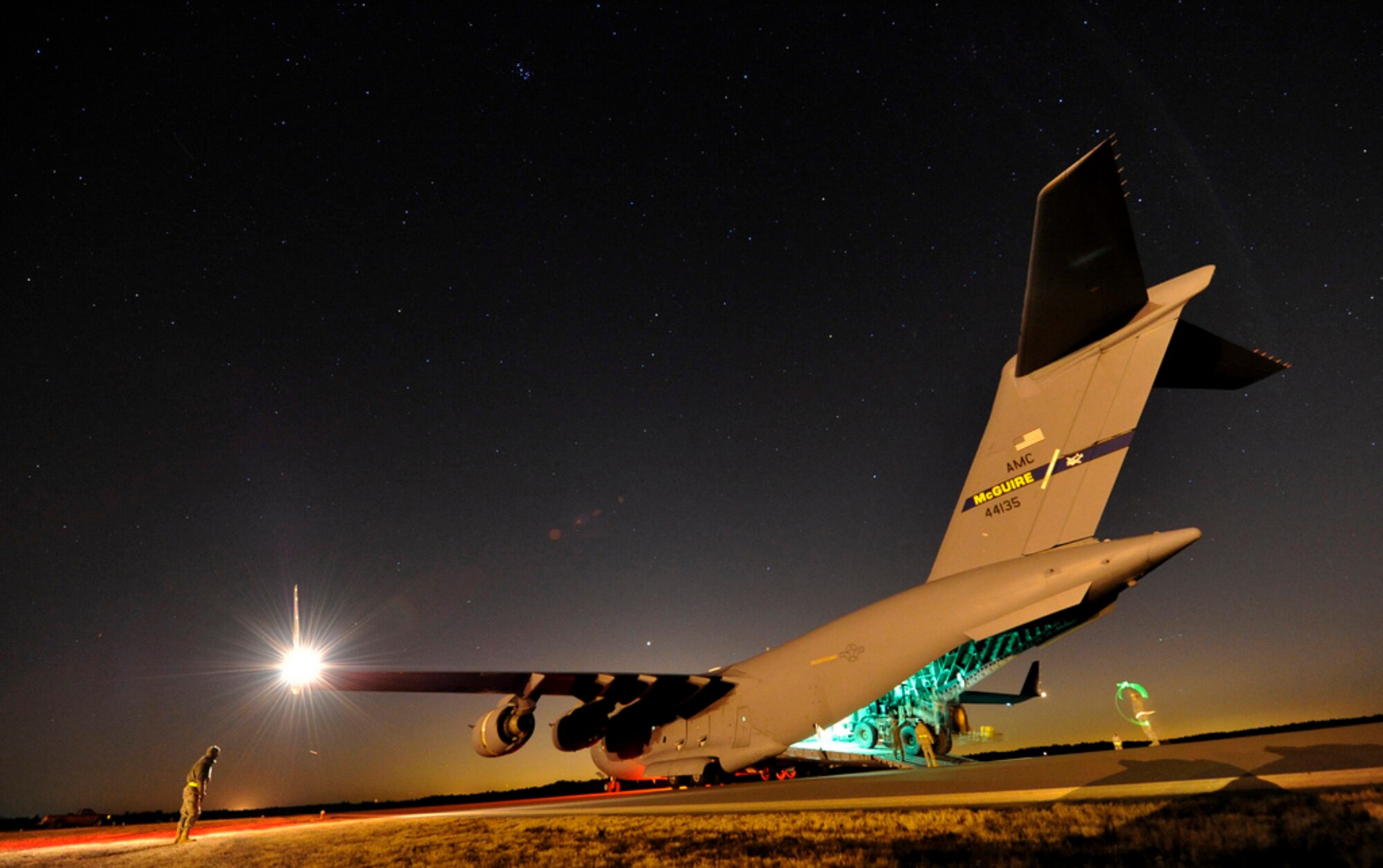 Aerial porters from the 621st Contingency Response Wing drive an articulated forklift from a 6th Airlift Squadron assigned C-17 Globemaster III during a nighttime engine-running offload at Lakehurst Feb. 23, 2013. The Airmen were participating in a field training exercise to hone the wing’s ability to deploy worldwide to austere locations and provide mobility airlift support. (U.S. Air Force photo by Tech. Sgt. Parker Gyokeres/Released)