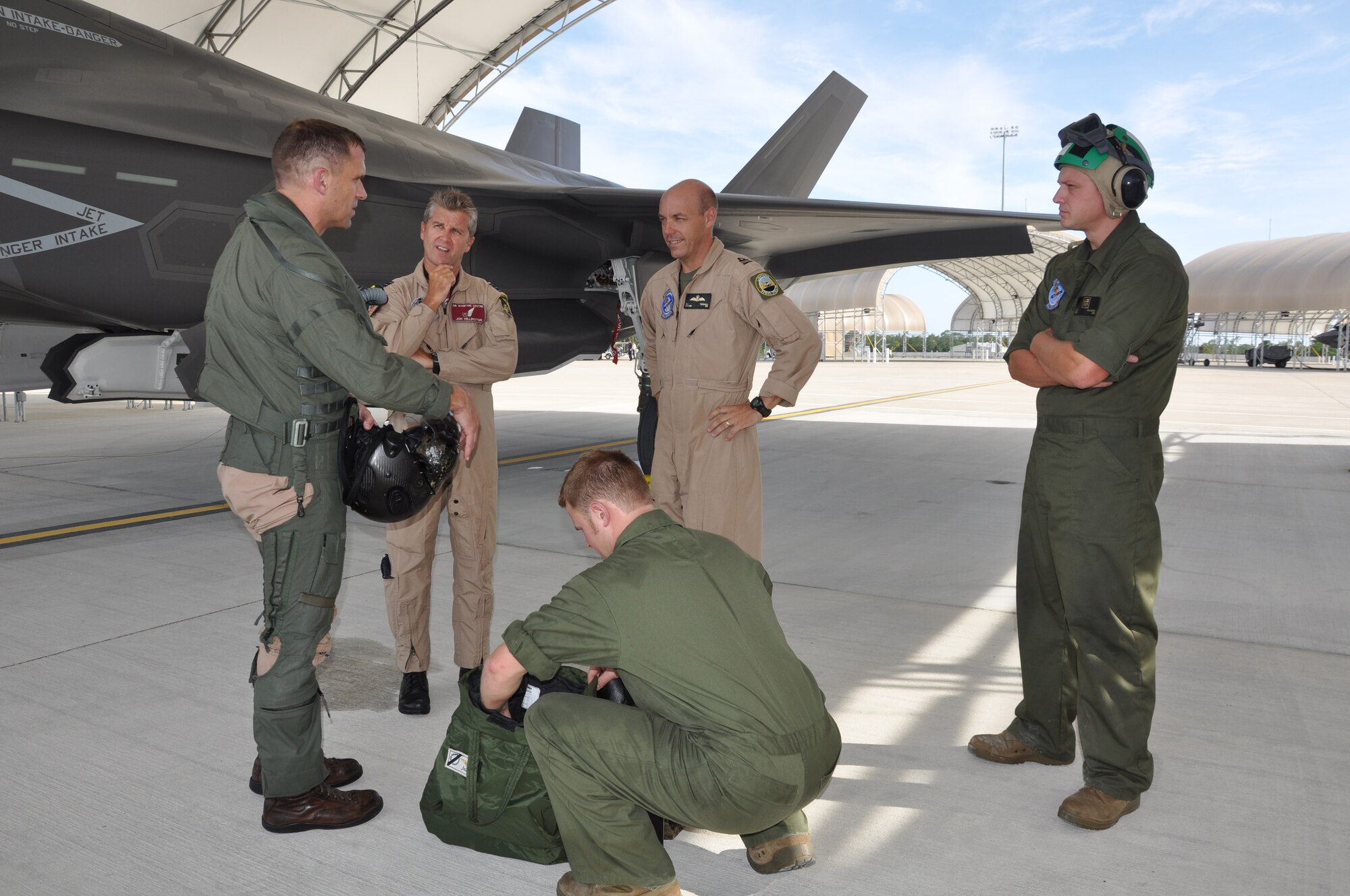 Marine Lt. Col. Roger Hardy, Defense Contract Management Agency F-35 Lightning
II acceptance pilot, at DCMA office, Lockheed Martin Ft. Worth, Texas talks
over another successful landing at Eglin Air Force Base, Fla., with a team
comprise of United Kingdom pilots and maintainers June 25, 2013. Hardy flew in the
last of three F-35B variants owned by the United Kingdom and slated to be
flown with the other joint strike fighters at the Marine Fighter Attack
Training Squadron-501 here. (U.S. photo/Maj. Karen Roganov)
