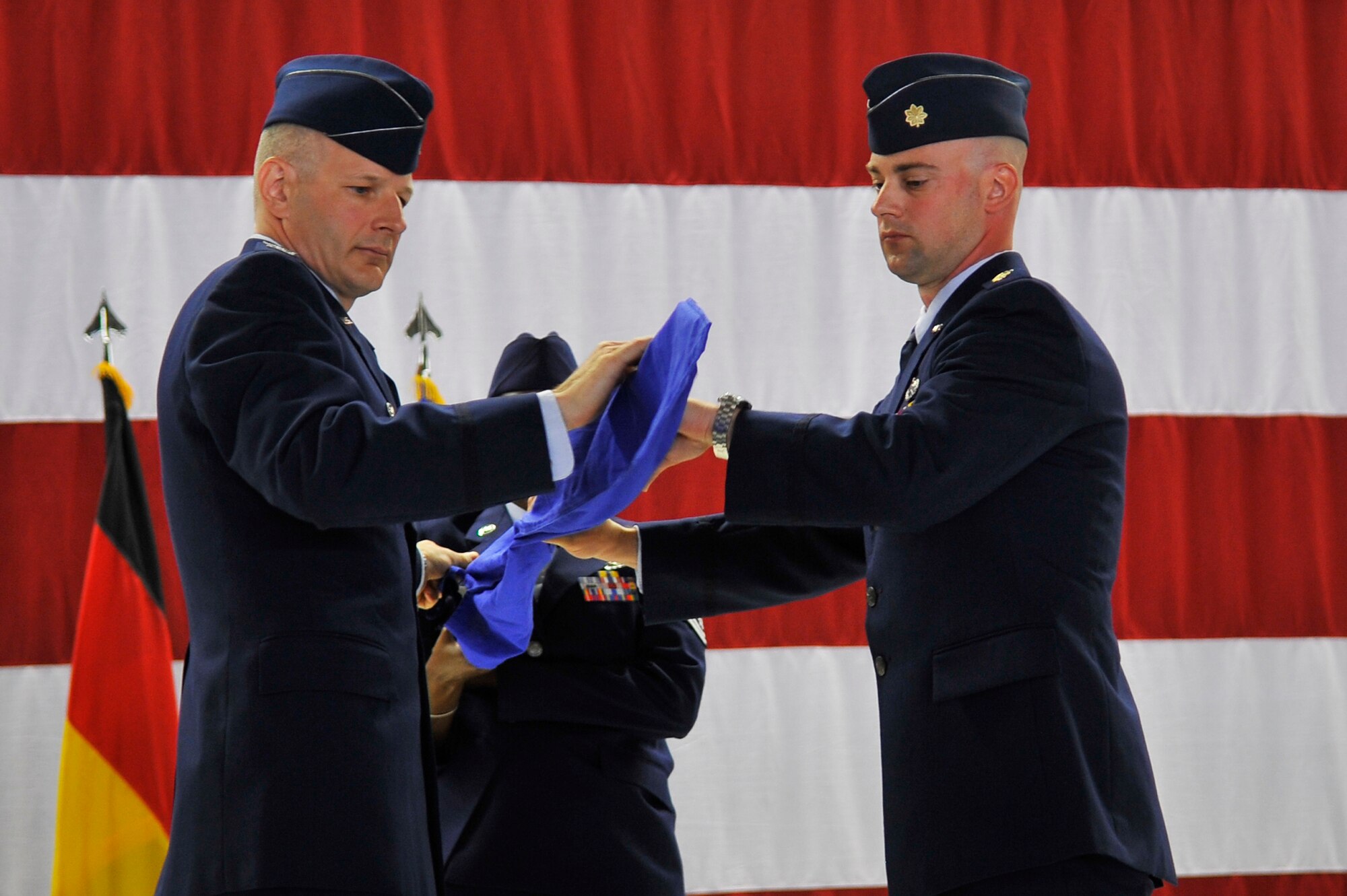 Col. Raymond Briggs, 86th Maintenance Group commander (left), and Maj. Mark Ashman 86th Maintenance Operations Squadron (right), furl the squadron flag during the 86th MOS inactivation ceremony, July 1, 2013, Ramstein Air Base, Germany. The 86th MOS was inactivated and reorganized into the 86th Maintenance Group. (U.S. Air Force photo/Airman 1st Class Trevor Rhynes)