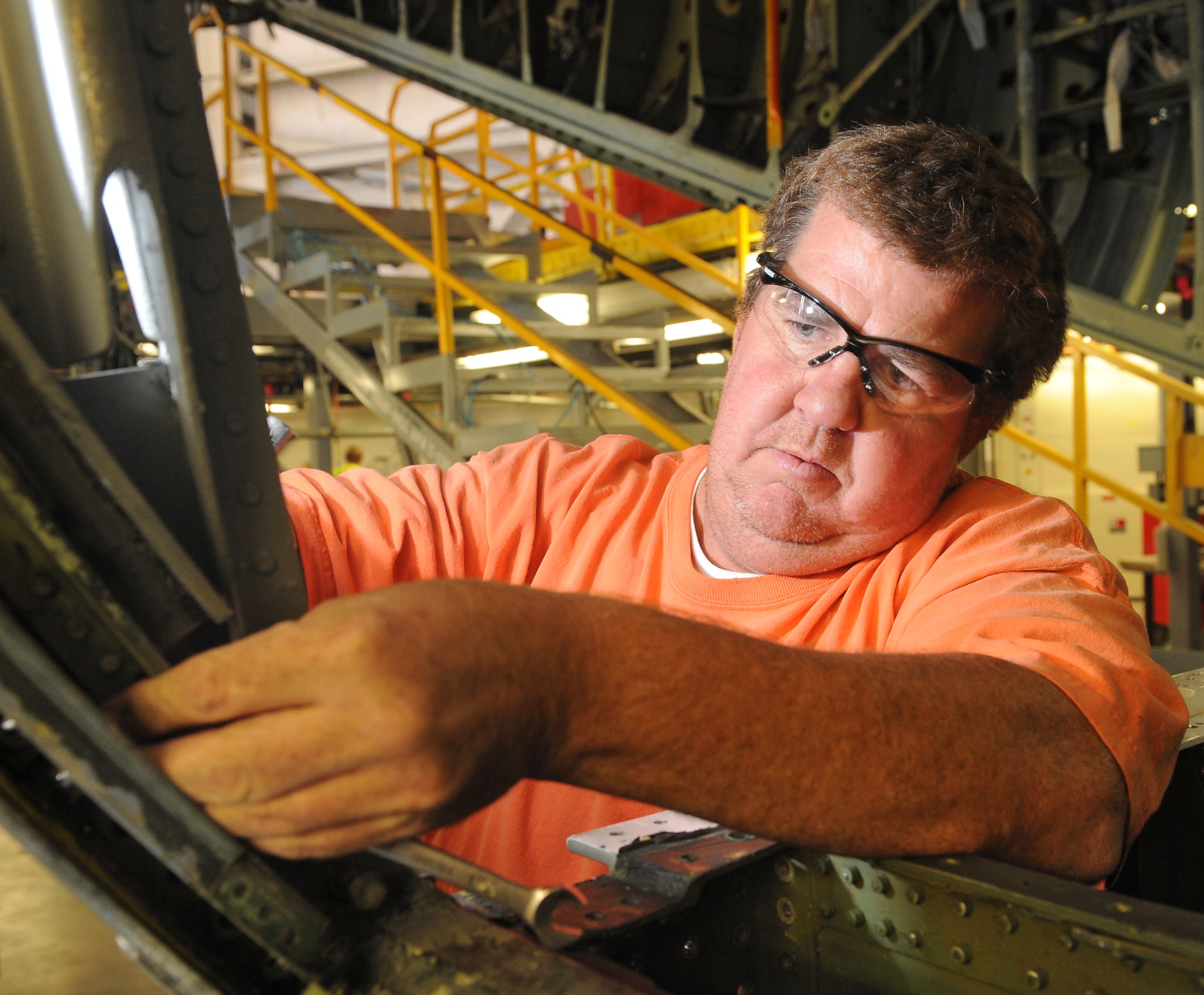 Joseph “Dusty” Mullis works on removing bolts from the Pork Chop Fitting on a C-130 at Hill AFB, Utah, on Friday. Mullis and 42 other civilian personnel from Robins are currently providing support to the workforce at the Ogden Air Logistics Complex. (US. Air Force photo by Alex Lloyd/Released)