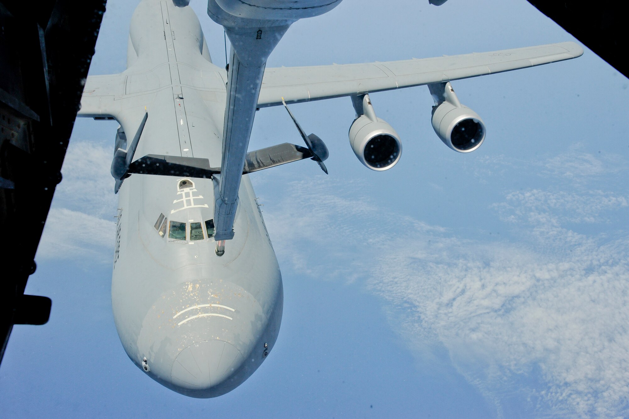 A KC-10 Extender from the 305th Air Mobility Wing at Joint Base McGuire-Dix-Lakehurst, N.J., refuels a C-5 Galaxy June 27, 2013. The refueling was part of a training mission for the 305th Operations Group Formal Training Unit which educates new pilots, boom operators and flight engineers to become effective crewmembers in a multi-crew aircraft. (U.S. Air Force photo by Airman Tara A. Williamson/Released)