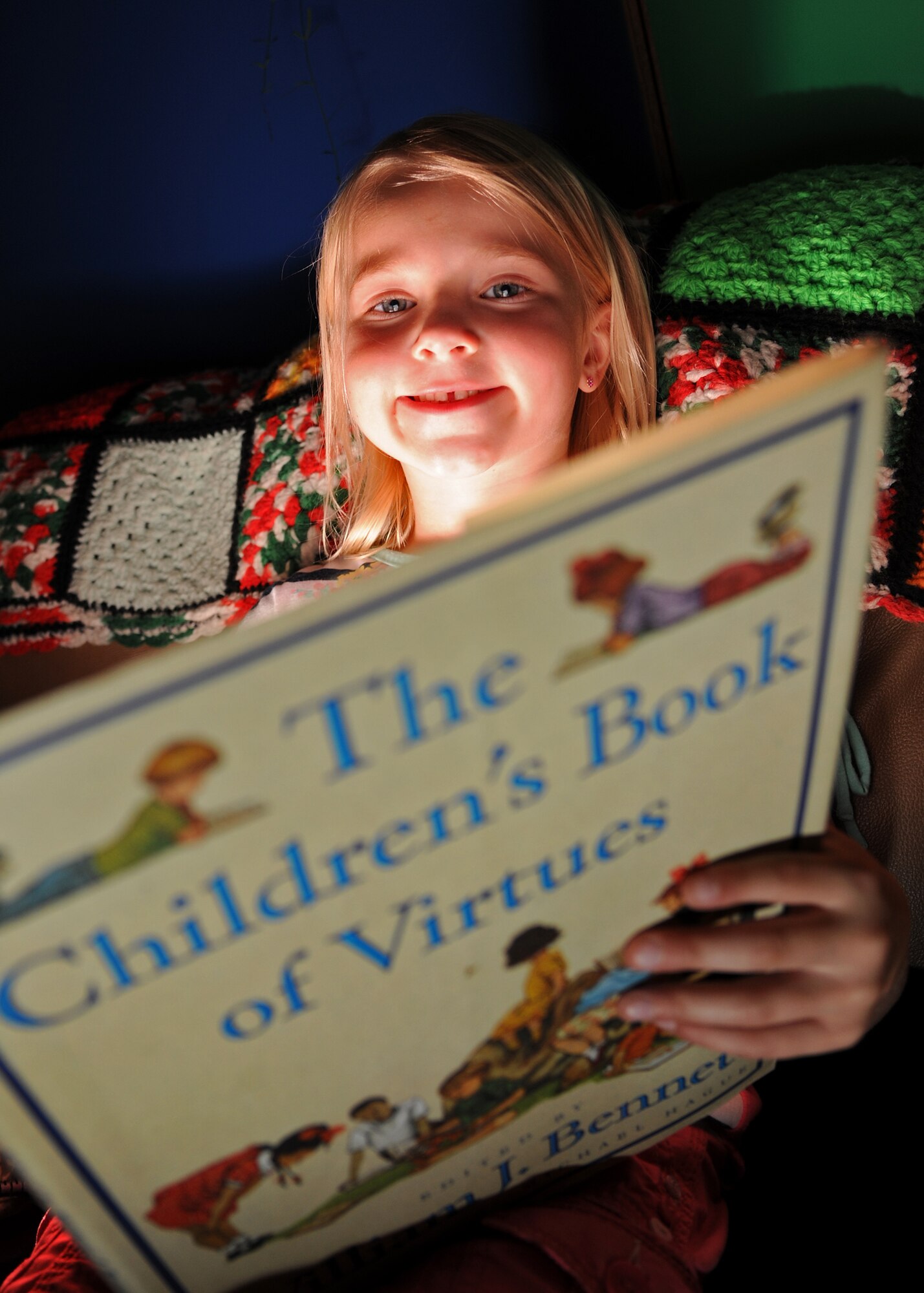 Isabell Taylor, 6, daughter of Master Sgt. Jessica Taylor of the 319th Air Base Wing and Tech. Sgt. Ray Taylor of the 319th Civil Engineer Squadron, reads “The Children’s Book of Virtues,” by William Bennett, at the Youth Center, July 1, 2013, on Grand Forks Air Force Base, N.D. Taylor won a Kindle Fire and a $10 Amazon gift card for placing eighth out of more than 2,100 youth participating in the Air Force’s “One Page at a Time Program.” (U.S. Air Force photo/Airman 1st Class Ashley Nicole Taylor)