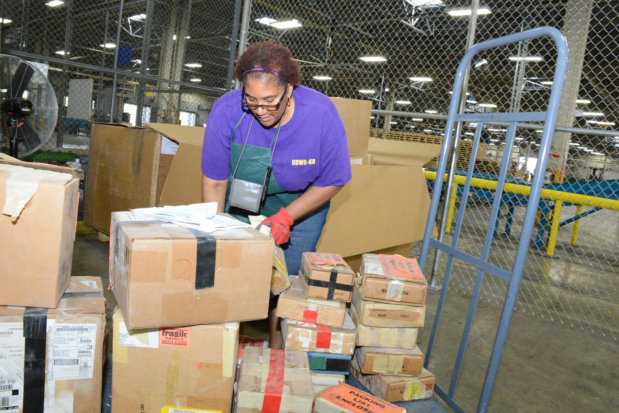 Elenore Howard, a DLA worker, processes incoming materials of all shapes and sizes. (U. S. Air Force photo by Edward Aspera)