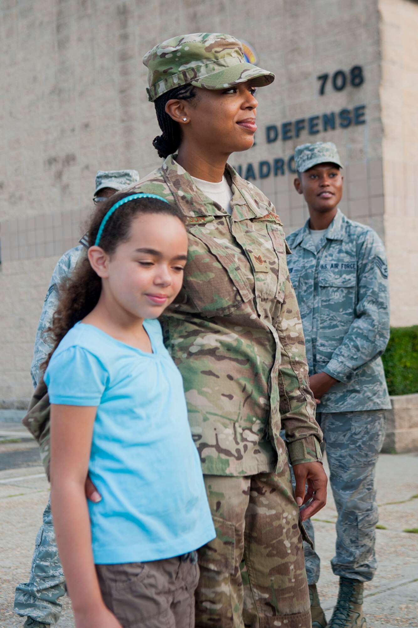 U.S. Air Force Staff Sgt. Andrea Jefferson, 823d Base Defense Squadron independent duty medical technician, wraps her arm around her daughter, Arianna. Jefferson is part of an approximately 150-person group that deployed. (U.S. Air Force photo by Airman 1st Class Sandra Marrero/released)