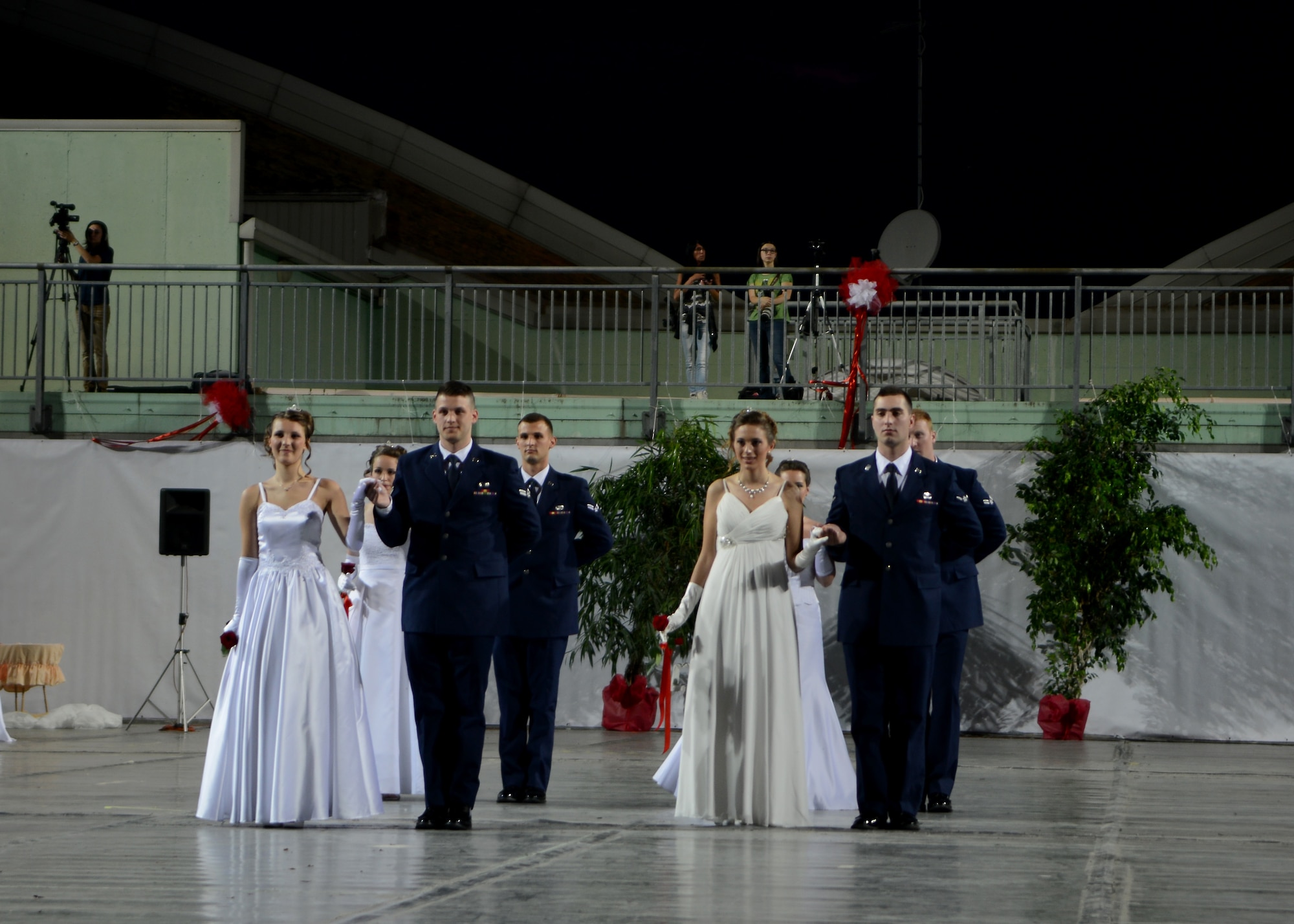 (From left) Airman 1st Class Joshua Blackburn and Airman Ryan Conroy present their debutants during the 15th edition of Ballo delle Debuttanti June 30, 2013, in Cordenons, Italy. The ball hosted 38 debutants that were accompanied by members from the 31st Fighter Wing, the 132nd Brigata corazzata (armored brigade) and other local Italians. (U.S. Air Force photo/Staff Sgt. Evelyn Chavez)