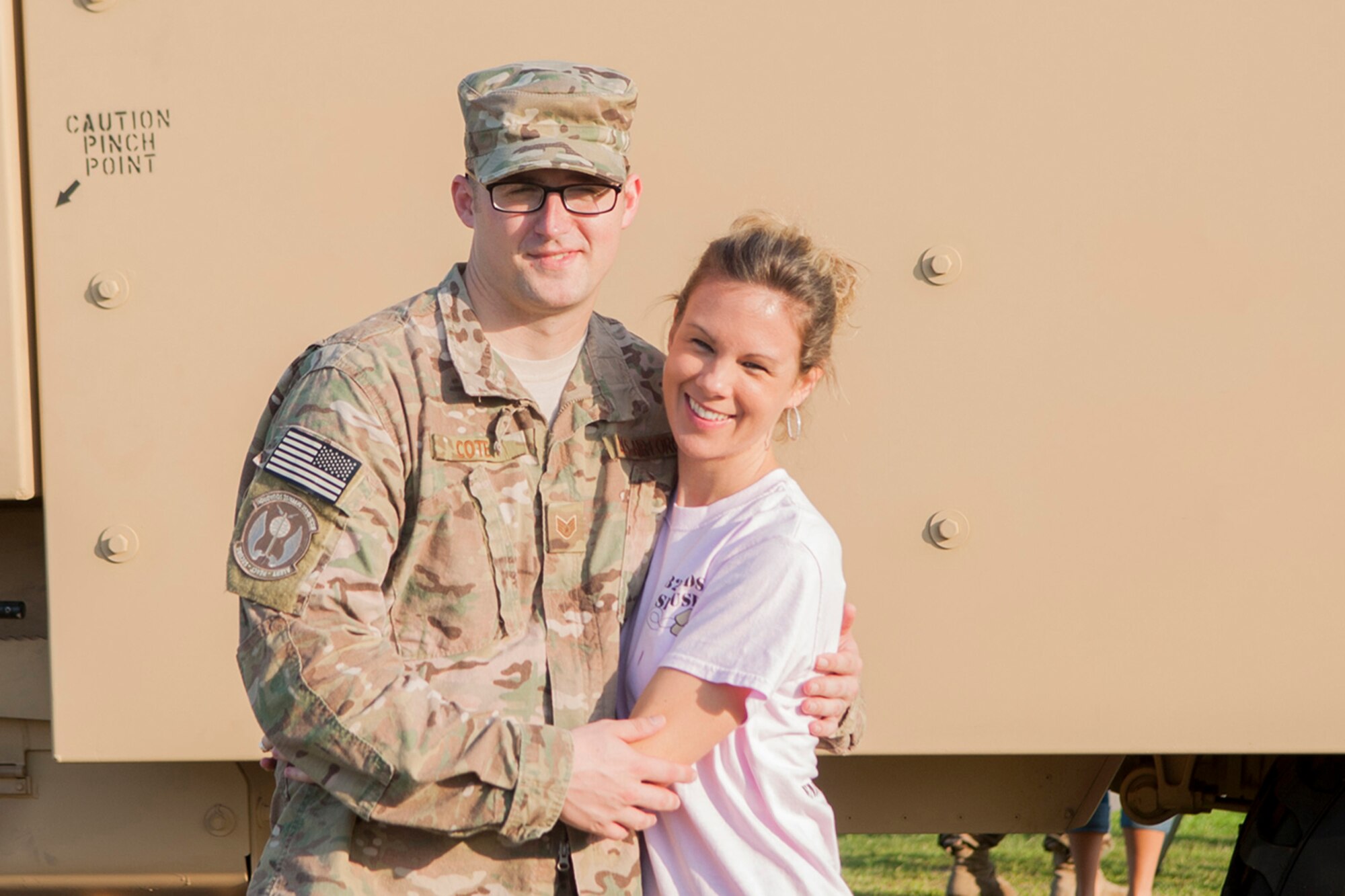 U.S. Air Force Staff Sgt. David Cote, 823d Base Defense Squadron fireteam leader, and his wife, Jenny pose for a photo. June 28, 2013 at Moody Air Force Base, Ga. Cote’s aunt and other family members were there to bid him farewell before his depolyment. (U.S. Air Force photo by Airman 1st Class Sandra Marrero/released)
