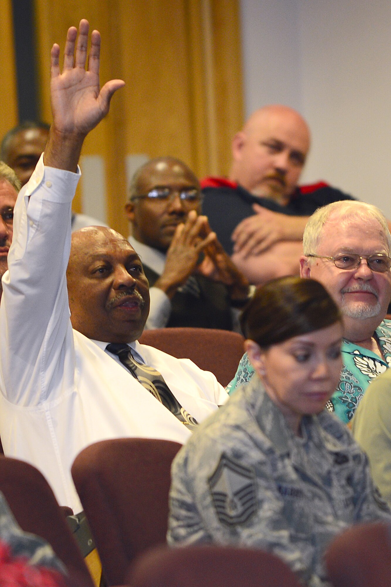 ROYAL AIR FORCE LAKENHEATH, England -- Department of Defense civilian employees participate in a question and answer session during a town hall meeting at the Strike Eagle Complex July 1, 2013, to discuss administrative furlough days. A furlough places an employee in a temporary non-duty, non-pay status because of lack of work, reduction or lack of funds, or other non-disciplinary reason. The upcoming government furlough will be 11 days, or 88 work hours, from July 8 to Sept. 30. (U.S. Air Force photo by Airman 1st Class Dana J. Butler) 