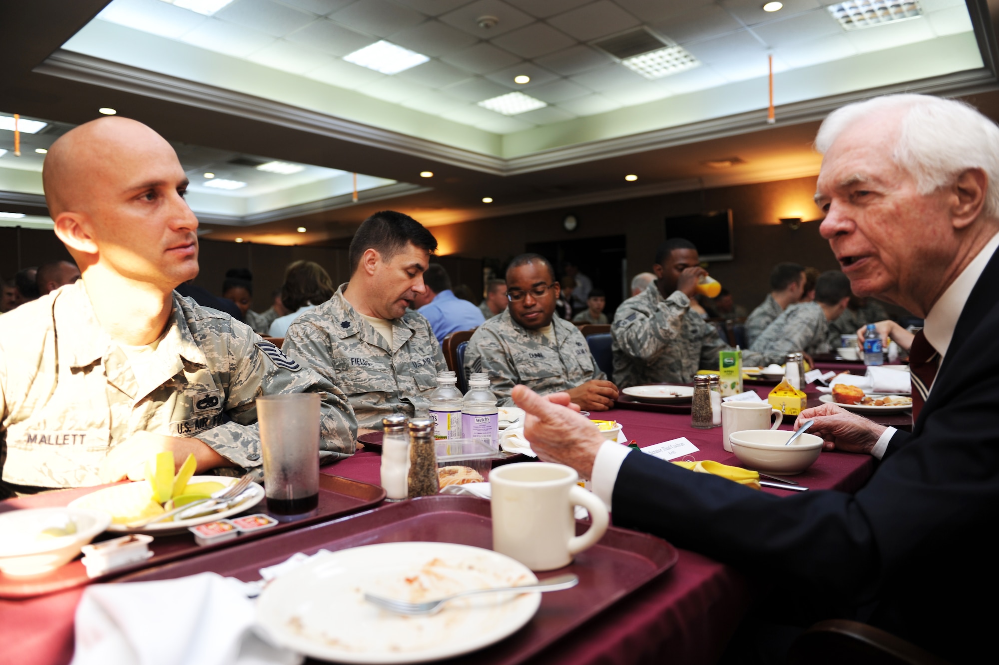 Tech. Sgt. Derrick Mallett, 39th Maintainence Squadron NCO in charge of munitions inspections, listens to Thad Cochran, U.S. senator from Mississippi over breakfast July 2, 2013, at Incirlik Air Base, Turkey. A delegation of six congressmen visited Incirlik AB during a trip to the local area. (U.S. Air Force photo by Senior Airman Chase Hedrick/Released)