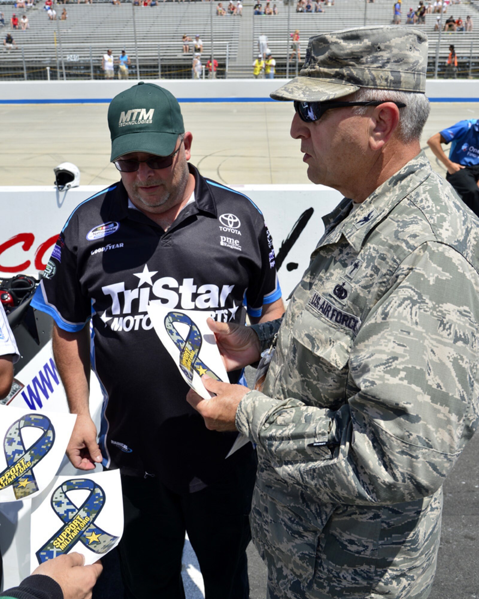 Chaplain (Col.) Steven West, 633rd Air Base Wing at Joint Base Langley-Eustis, Va., talks with a crew member for Mike Bliss, driver of the No. 19 TriStar Motorsports Chevy, June 1, 2013, at Dover International Speedway in Dover, Del. West is the cofounder of the Support Military Foundation. (U.S. Air Force photo/David S. Tucker)