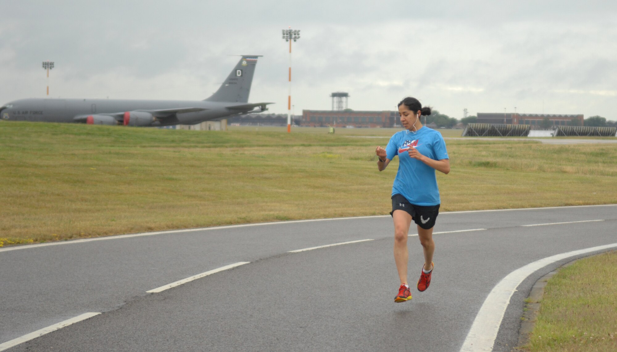 Staff Sgt. Jessica Garcia, 100th Security Forces Squadron NCO in charge of the Visitor Control Center from Apple Valley, Minn., nears the finish line of a 5K run July 3, 2013, to kick off Independence Day celebration events on RAF Mildenhall, England. Garcia was the first to finish the run. (U.S. Air Force photo by Airman 1st Class Dillon Johnston/Released)
