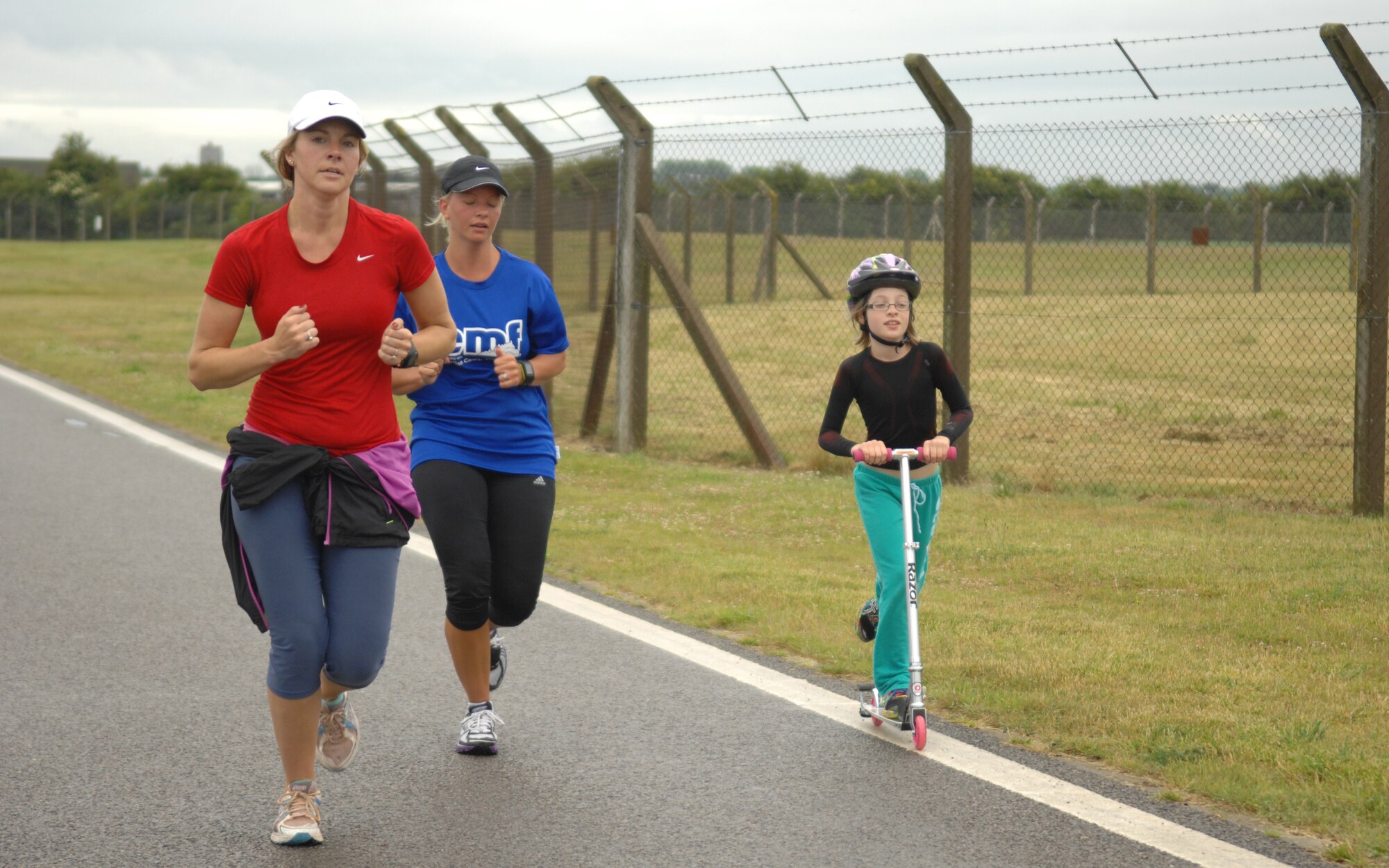 Team Mildenhall members participate in a 5K run July 3, 2013, to kick off Independence Day celebration events on RAF Mildenhall, England. The celebration consists of multiple family-friendly events spanning the entire day. (U.S. Air Force photo by Airman 1st Class Dillon Johnston/Released)