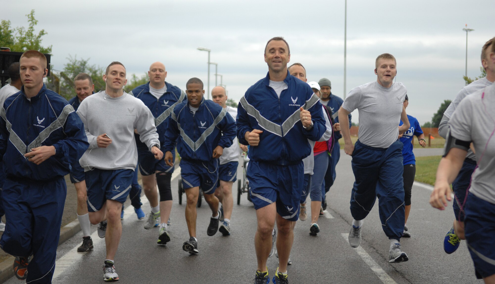 Team Mildenhall members begin a 5K run July 3, 2013, to kick off Independence Day celebration events on RAF Mildenhall, England. The celebration consists of multiple family-friendly events spanning the entire day. (U.S. Air Force photo by Airman 1st Class Dillon Johnston/Released)