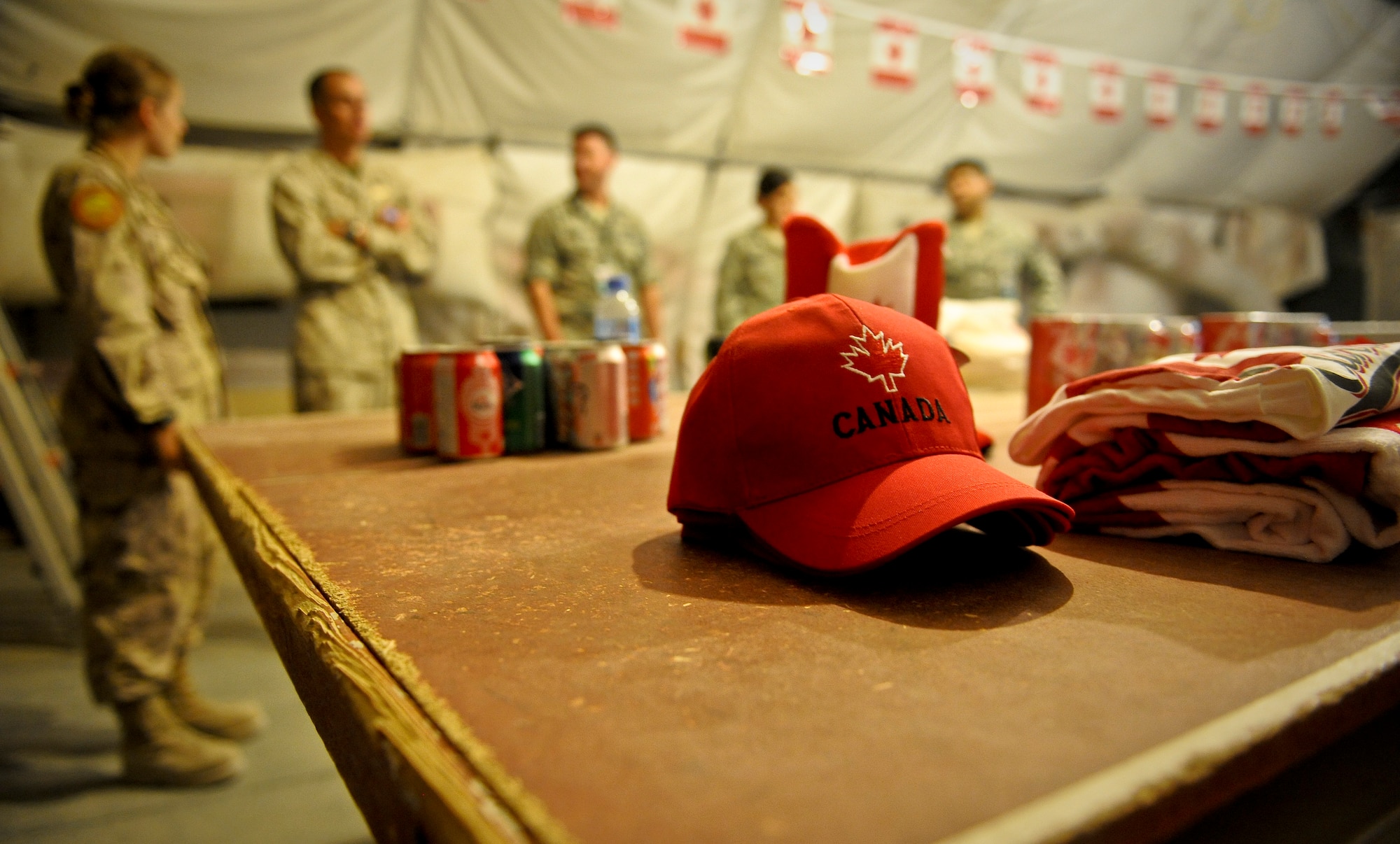 With Canadian flags strung from corner to corner, maple syrup candies on every table, and Canadian paraphernalia at every turn, Canadian, U.S., Australian, coalition and mission partners celebrated Canada?s birthday July 1, 2013, at the 379th Air Expeditionary Wing in Southwest Asia. The evening?s activities ranged from a Canadian trivia game to a guitar solo to board games. (U.S. Air Force photo/Senior Airman Benjamin Stratton)