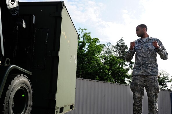 Airman 1st Class Fabio Deavers, 86th Vehicle Readiness Squadron vehicle operator, guides a forklift driver away from a pallet during a safety stand-down day, June 28, 2013 at Ramstein Air Base, Germany. U.S. Air Forces in Europe and Air Forces Africa units participated in a safety stand-down day to emphasize the importance of MHE safety. (U.S. Air Force photo/Staff Sgt. Travis Edwards)